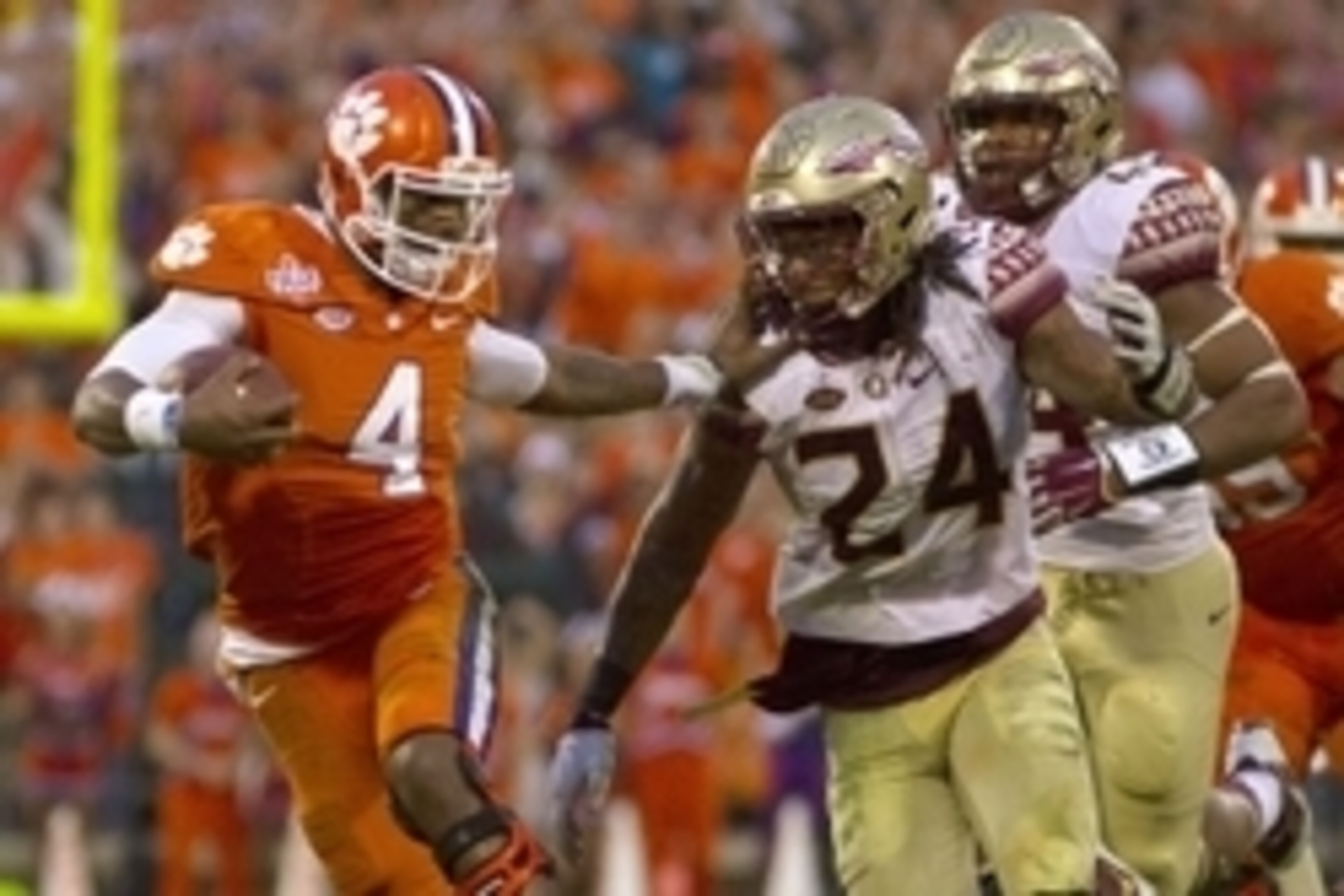 Nov 7, 2015; Clemson, SC, USA; Clemson Tigers quarterback Deshaun Watson (4) carries the ball while being defended by Florida State Seminoles linebacker Terrance Smith (24) during the first half at Clemson Memorial Stadium. Mandatory Credit: Joshua S. Kel Nov 7, 2015; Clemson, SC, USA; Clemson Tigers quarterback Deshaun Watson (4) carries the ball while being defended by Florida State Seminoles linebacker Terrance Smith (24) during the first half at Clemson Memorial Stadium. Mandatory Credit: Joshua S. Kel