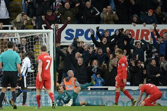 Newcastle fans react after Liverpool's Slovakian defender Martin Skrtel (R) scored an own goal following a cross by Newcastle United's Dutch midfielder Georginio Wijnaldum (Not Pictured) during the English Premier League football match between Newcastle U