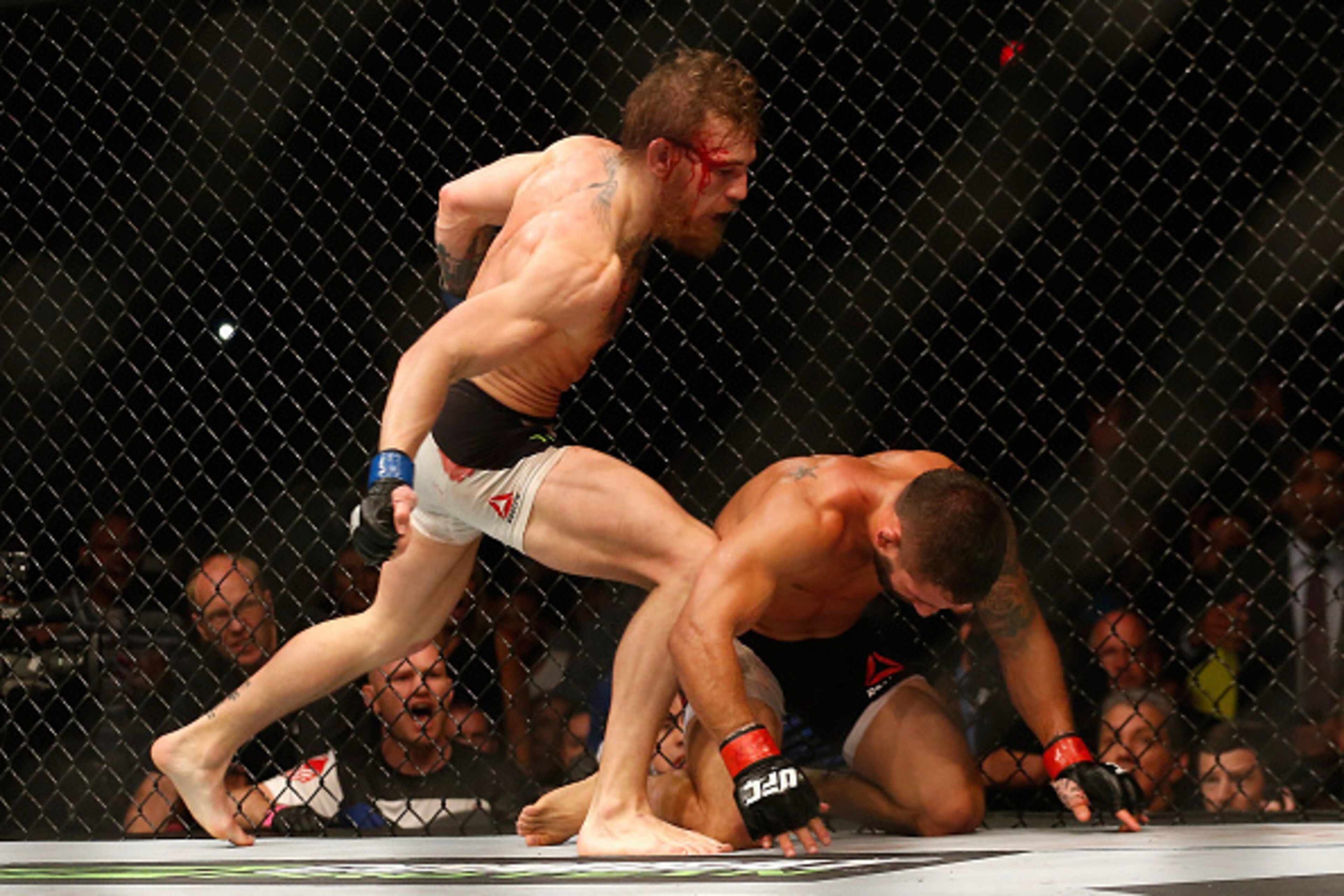 LAS VEGAS, NV - JULY 11:  (L-R) Conor McGregor punches Chad Mendes in their UFC interim featherweight title fight during the UFC 189 event inside MGM Grand Garden Arena on July 11, 2015 in Las Vegas, Nevada.  (Photo by Christian Petersen/Zuffa LLC/Zuffa L