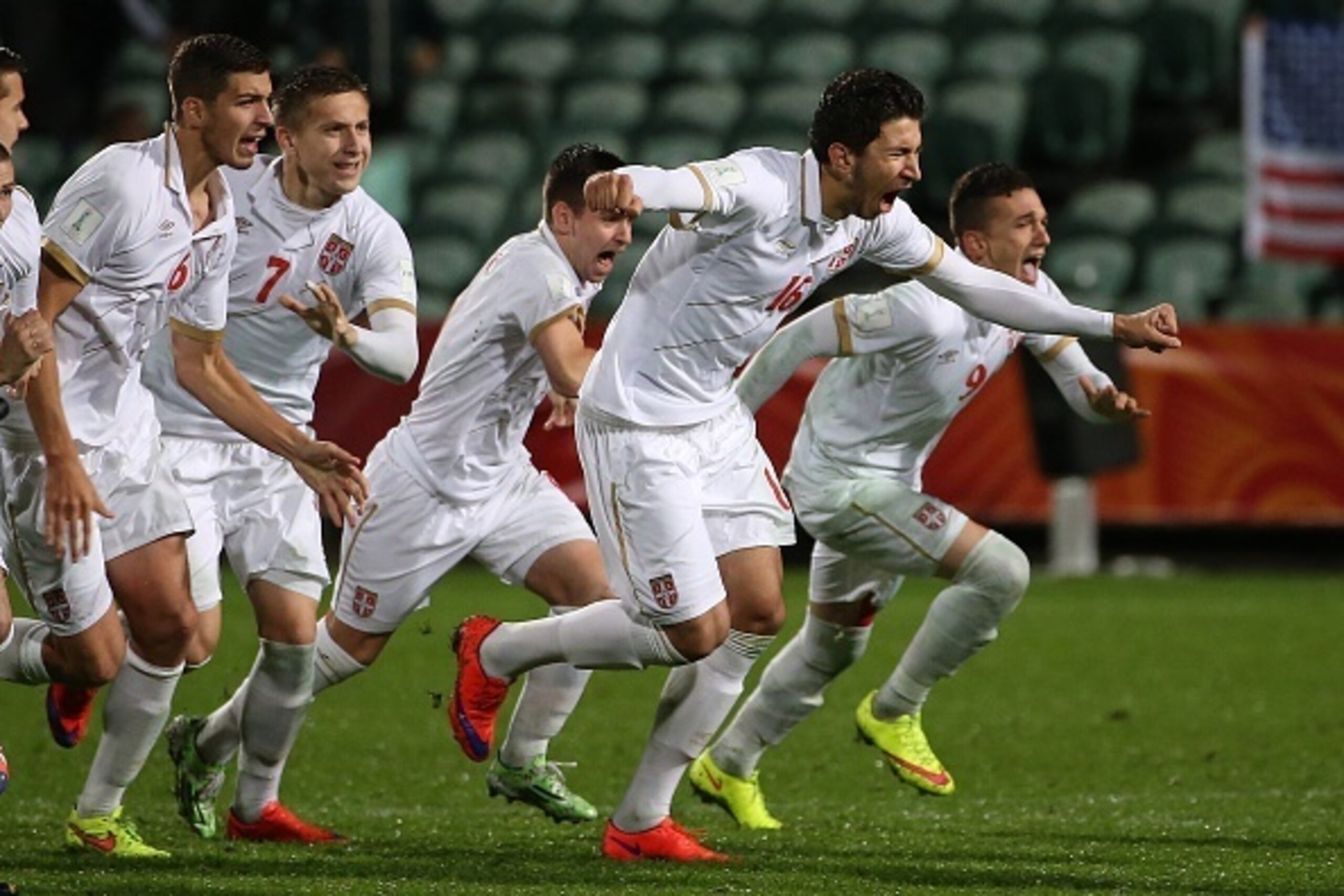 Marko Grujic of Serbia (2nd R) leads teammates as they celebrate their victory during a penalty shootout during the FIFA U20 World Cup quarter-final match between the USA and Serbia in Auckland on June 14, 2015.     AFP PHOTO / Fiona GOODALL        (Photo