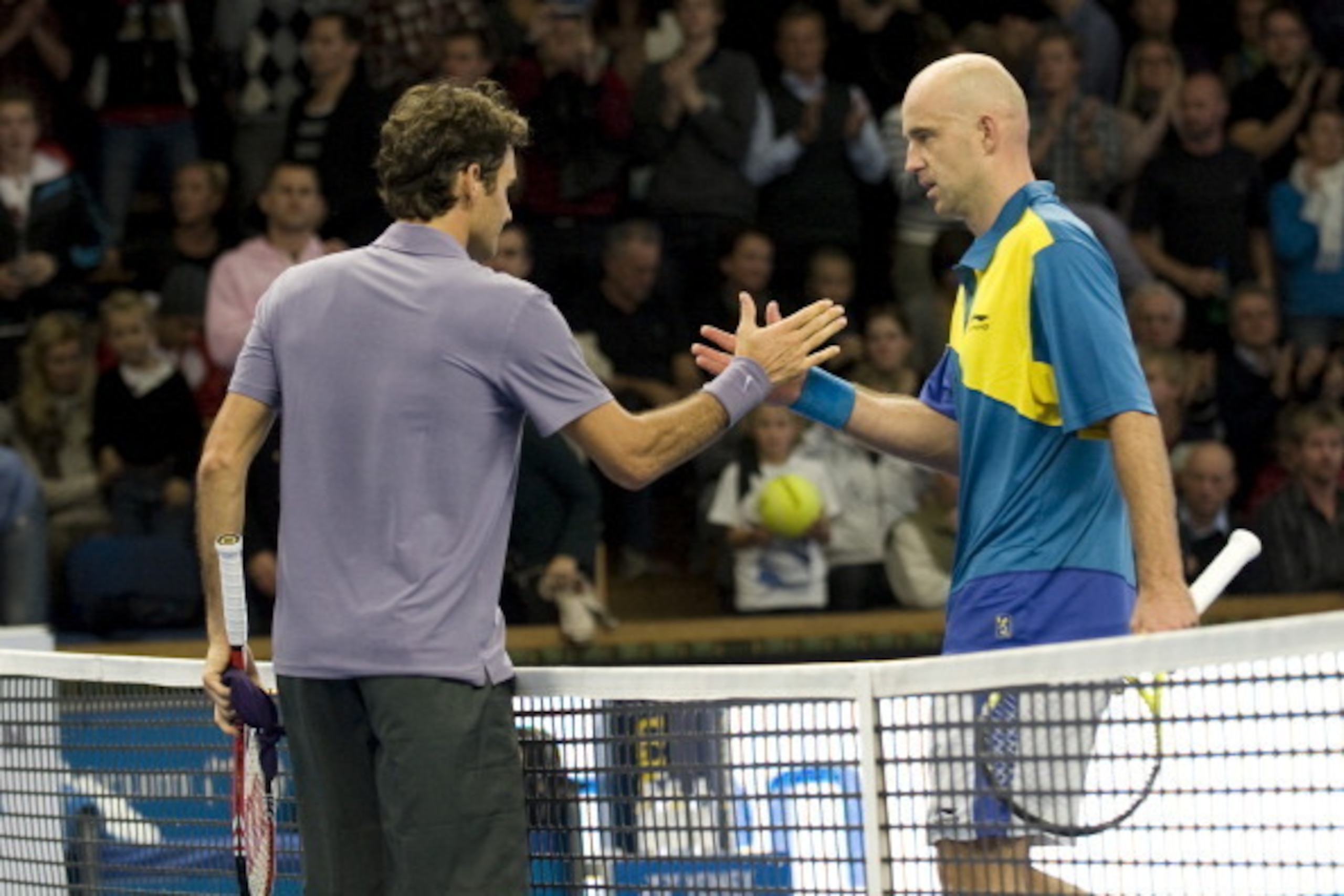 Switzerland tennis player Roger Federer (L) shakes hand with Croatia's Ivan Ljubicic at the end of their semi-finals game played as part of the ATP Stockholm Open tennis tournament on October 23, 2010 in Stockholm.Roger Federer beat Ivan Ljubicic 7-6 (5),