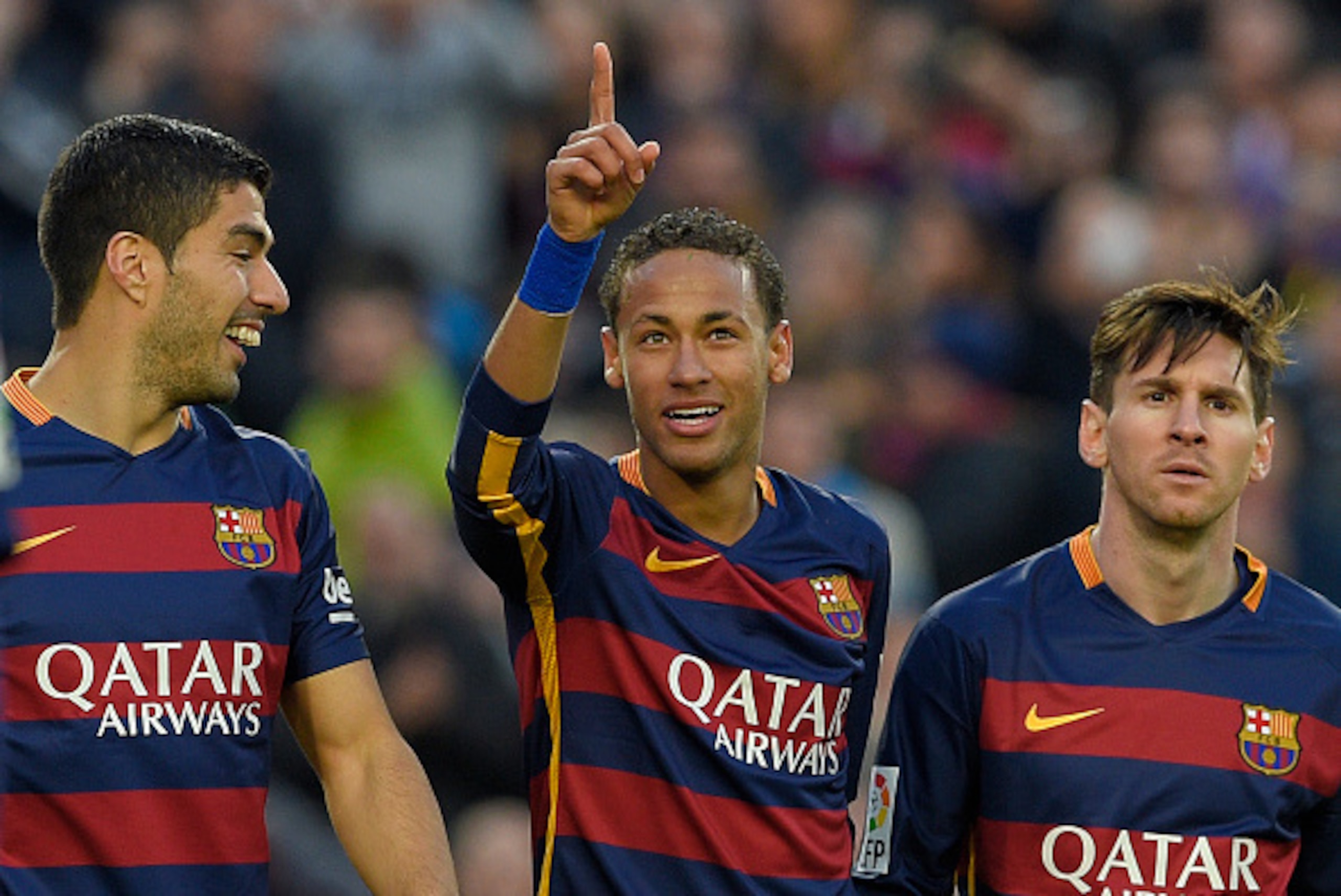 Barcelona's Brazilian forward Neymar (C) celebrates with Barcelona's Uruguayan forward Luis Suarez (L) and Barcelona's Argentinian forward Lionel Messi after scoring their third goal during the Spanish league football match FC Barcelona vs Real Sociedad d