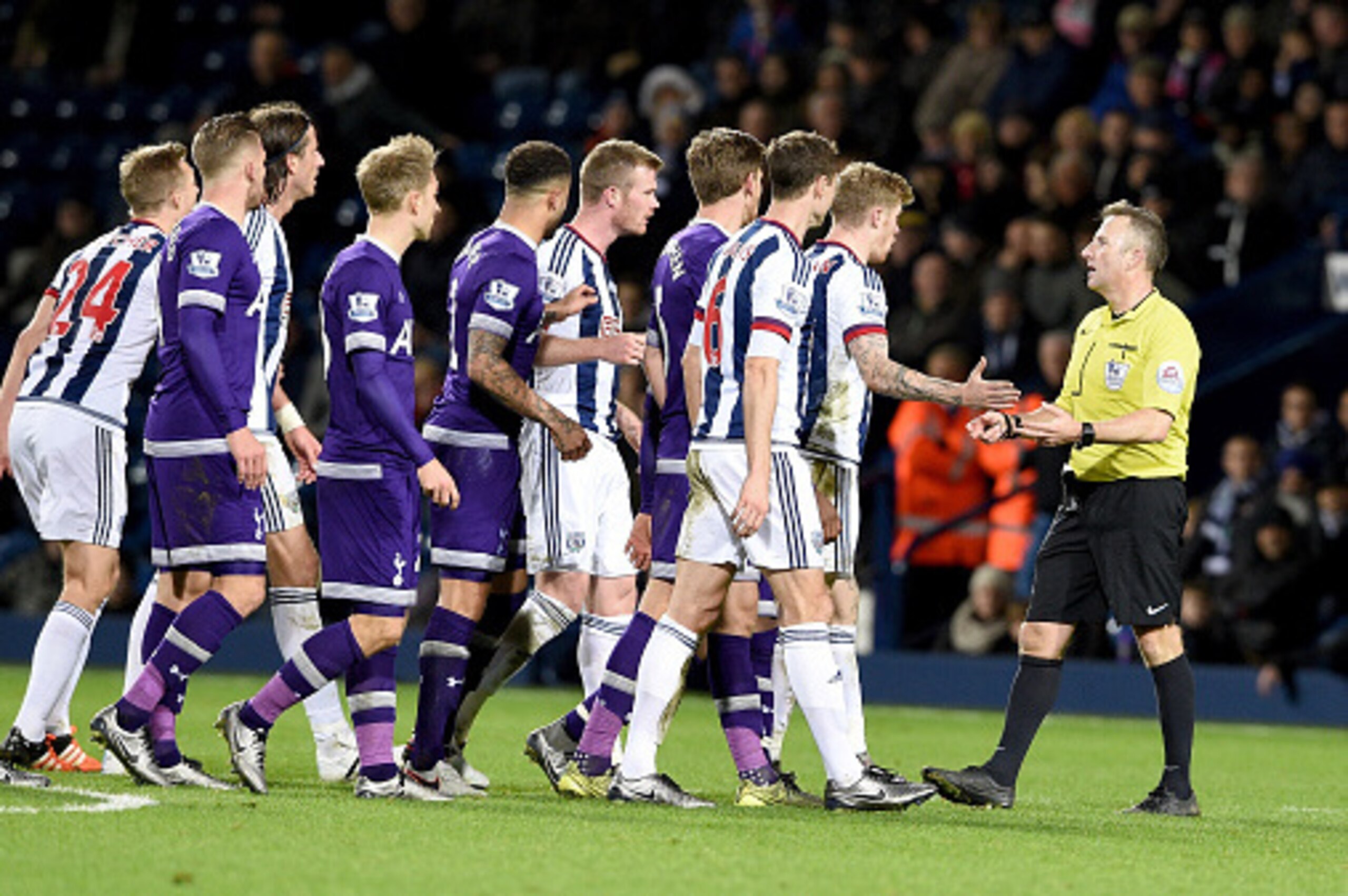 WEST BROMWICH, ENGLAND - DECEMBER 05: Referee, Jonathan Moss is confronted by players from both sides during the Barclays Premier League match between West Bromwich Albion and Tottenham Hotspur at the Hawthorns on December 5, 2015 in West Bromwich, Engla WEST BROMWICH, ENGLAND - DECEMBER 05: Referee, Jonathan Moss is confronted by players from both sides during the Barclays Premier League match between West Bromwich Albion and Tottenham Hotspur at the Hawthorns on December 5, 2015 in West Bromwich, Engla