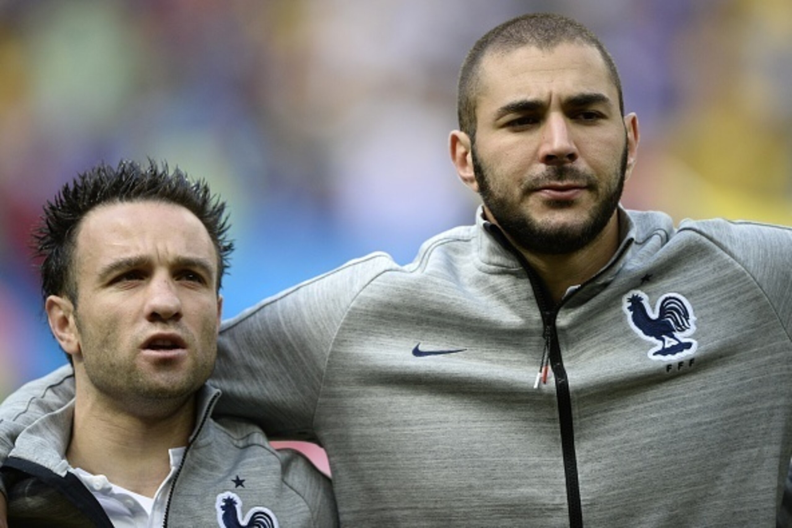 France's midfielder Mathieu Valbuena (L) and forward Karim Benzema listen to their national anthem before the round of 16 football match between France and Nigeria at the Mane Garrincha National Stadium in Brasilia during the 2014 FIFA World Cup on June 3