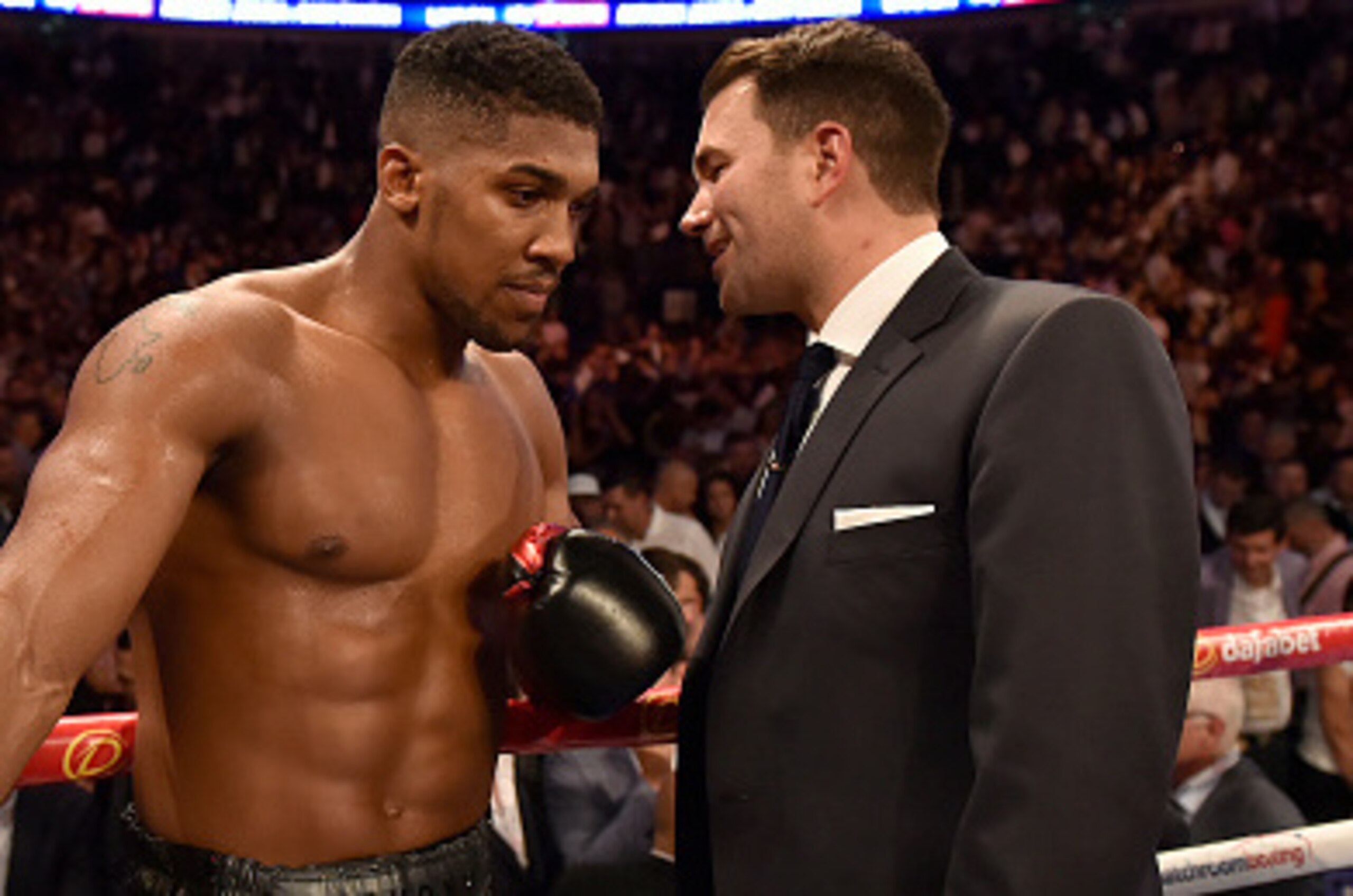 LONDON, ENGLAND - SEPTEMBER 12:  Anthony Joshua (r) talks to Matchroom Sport's promoter Eddie Hearn after he claimed the WBC International Heavyweight title & vacant Commonwealth Heavyweight title fight against Gary Cornish during 'Heavy Duty' fight night