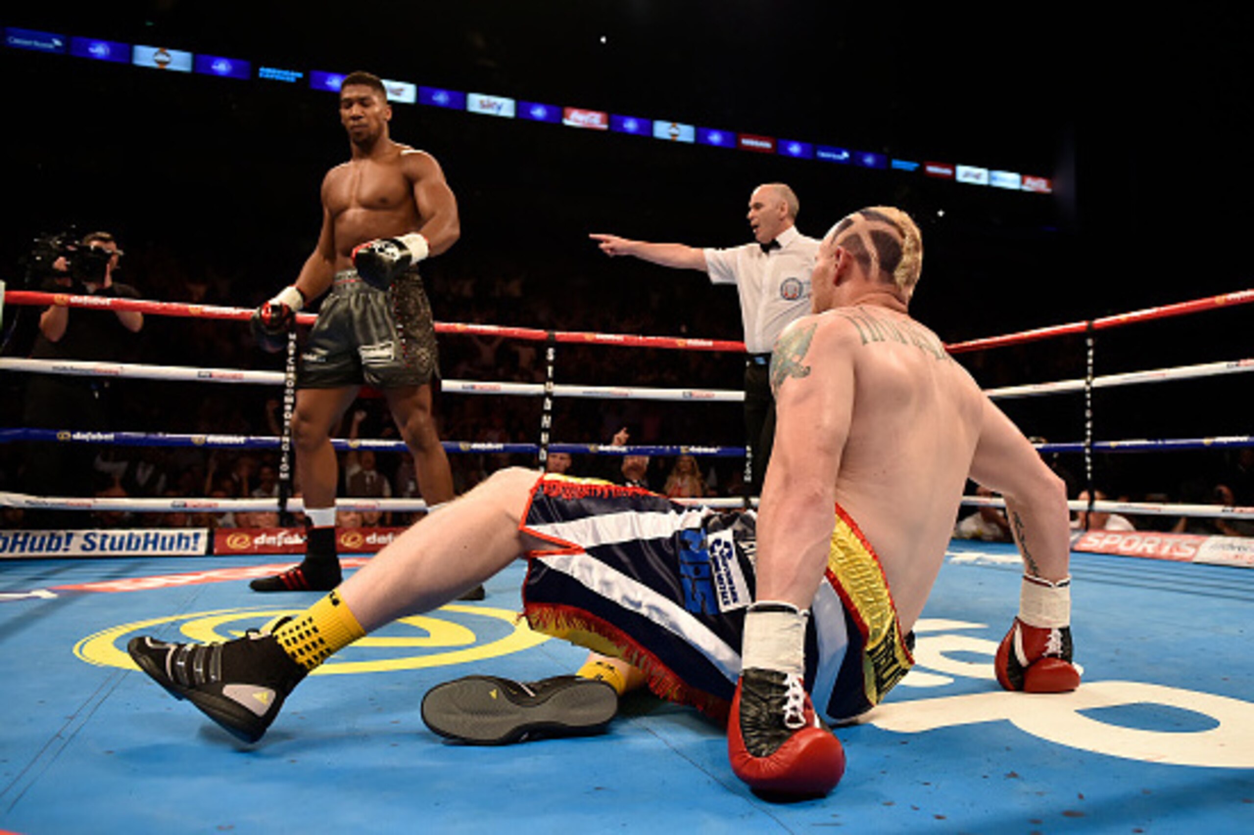 LONDON, ENGLAND - SEPTEMBER 12:  Anthony Joshua knocks down Gary Cornish in the first round of the WBC International Heavyweight title & vacant Commonwealth Heavyweight title during 'Heavy Duty' fight night at The O2 Arena on September 12, 2015 in London,