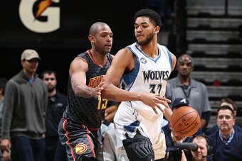 MINNEAPOLIS, MN -  NOVEMBER 25:  Karl-Anthony Towns #32 of the Minnesota Timberwolves posts up against Al Horford #15 of the Atlanta Hawks on November 25, 2015 at Target Center in Minneapolis, Minnesota. NOTE TO USER: User expressly acknowledges and agree