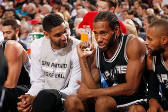 PORTLAND, OR - NOVEMBER 11: Tim Duncan #21 of the San Antonio Spurs and Kawhi Leonard #2 of the San Antonio Spurs during the game on November 11, 2015 at Moda Center in Portland, Oregon. NOTE TO USER: User expressly acknowledges and agrees that, by downlo