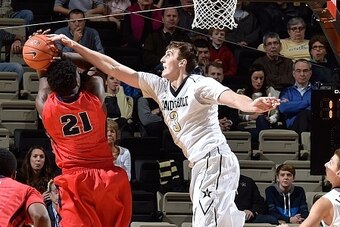 NASHVILLE, TN - DECEMBER 02:  Luke Kornet #3 of the Vanderbilt Commodores blocks a shot by Jaleel Hogan #21 of the Detroit Titans during the first half at Memorial Gym on December 2, 2015 in Nashville, Tennessee.  (Photo by Frederick Breedon/Getty Images)
