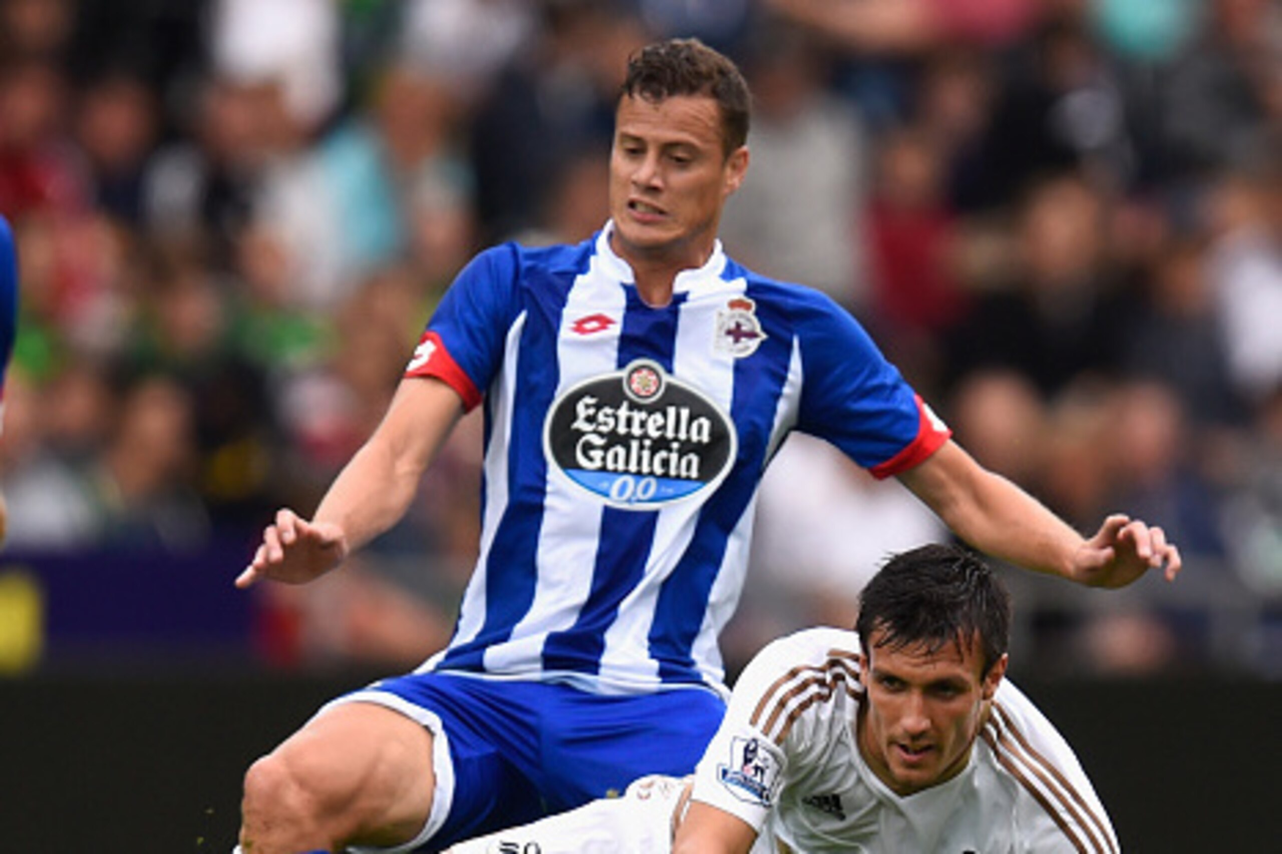 SWANSEA, WALES - AUGUST 01: Swansea player Jack Cork is fouled by Oriol Riera of Deportiva during the Pre season friendly match between Swansea City and Deportivo La Coruna at Liberty Stadium on August 1, 2015 in Swansea, Wales. (Photo by Stu Forster/Ge SWANSEA, WALES - AUGUST 01: Swansea player Jack Cork is fouled by Oriol Riera of Deportiva during the Pre season friendly match between Swansea City and Deportivo La Coruna at Liberty Stadium on August 1, 2015 in Swansea, Wales. (Photo by Stu Forster/Ge