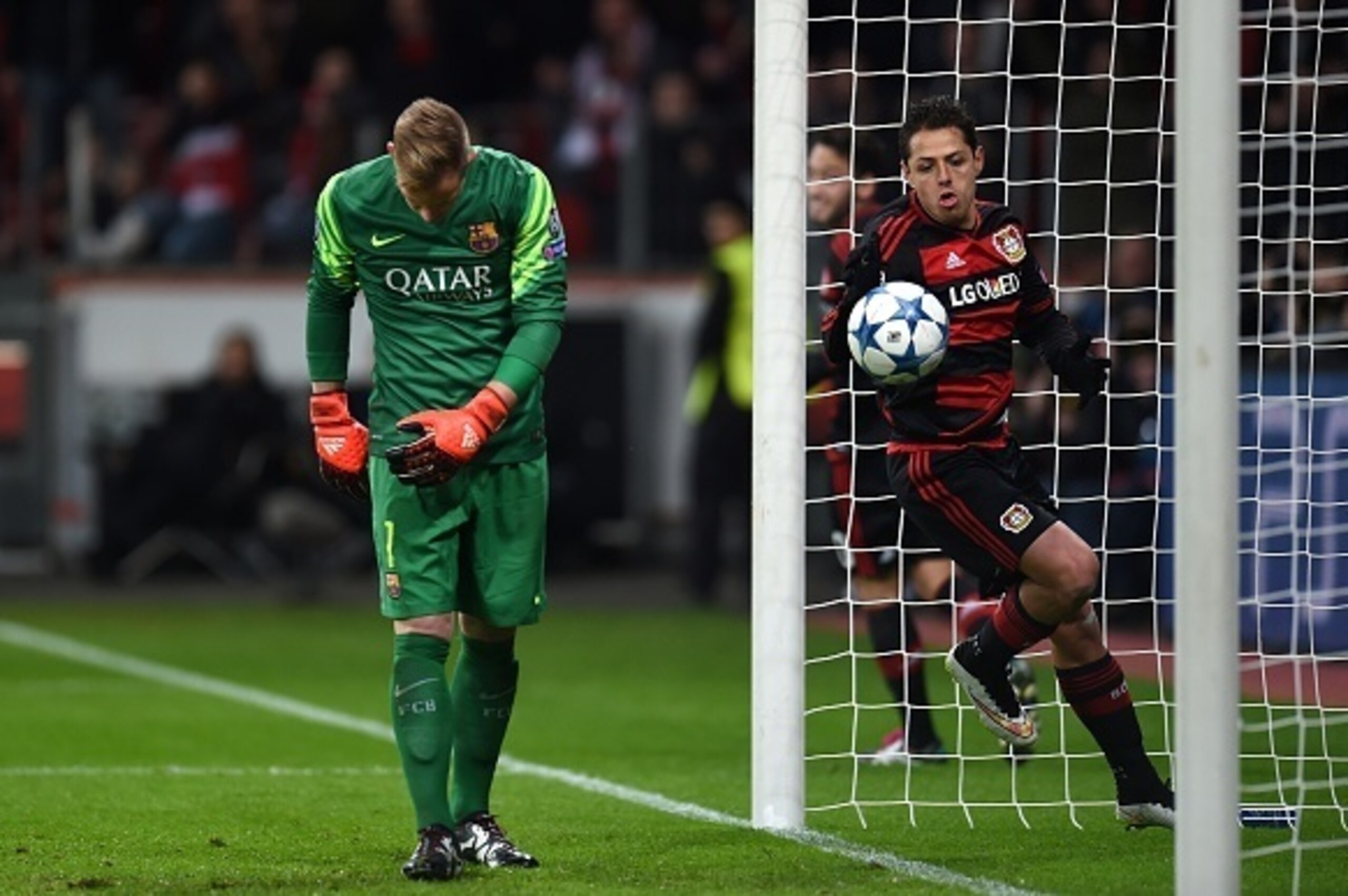 Leverkusen's Mexican striker Javier Hernandez scores past Barcelona's German goalkeeper Marc-Andre Ter Stegen during the Group E, second-leg UEFA Champions League football match Bayer 04 Leverkusen vs FC Barcelona in Leverkusen, western Germany on Decembe