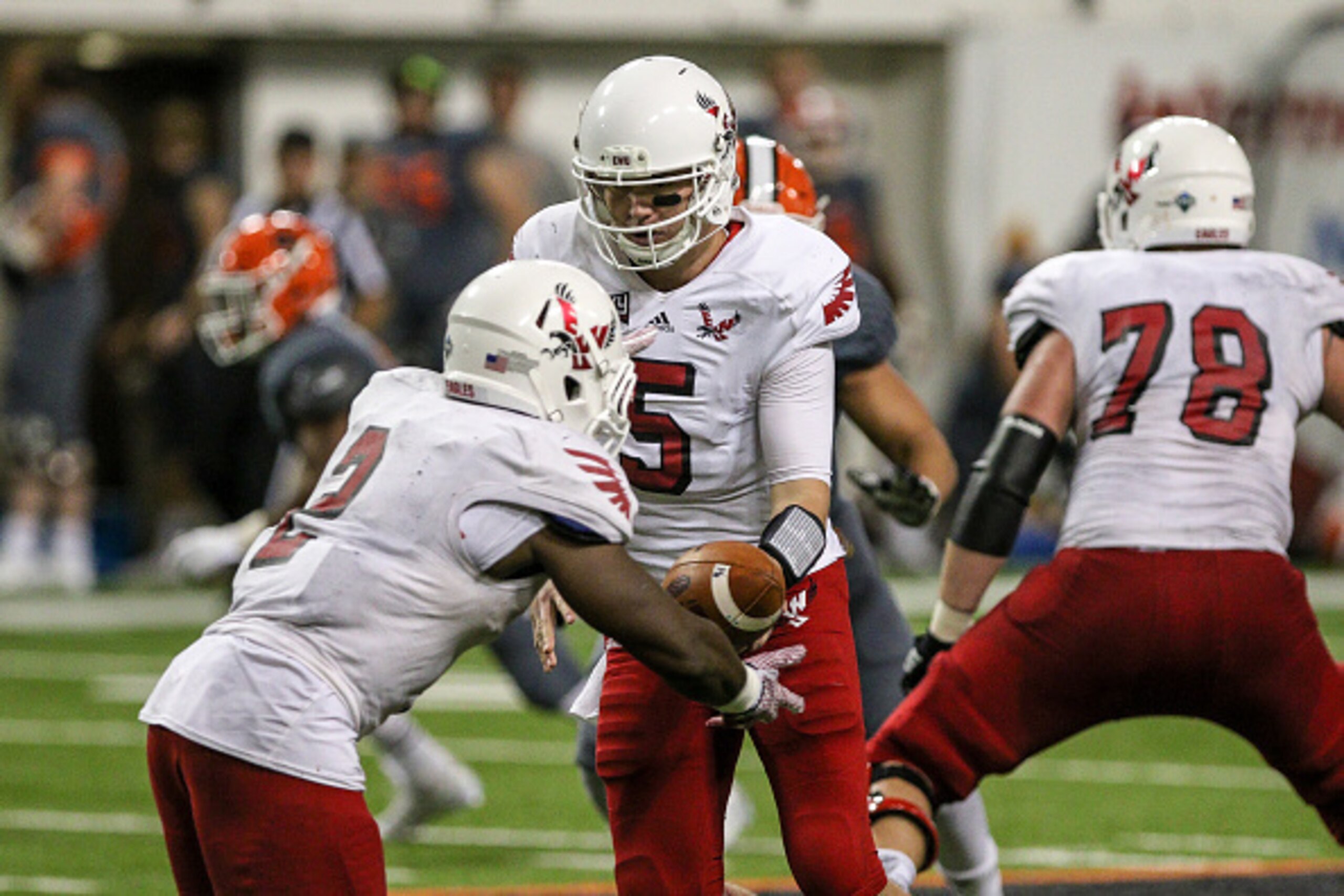 POCATELLO, ID - OCTOBER 17: Quarterback Jordan West #5 hands the ball off to running back Jabari Wilson #2 of the Eastern Washington Eagles during second half action against the Idaho State Bengals on October 17, 2015 at Holt Arena in Pocatello, Idaho. Ea