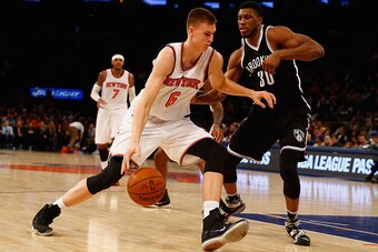 NEW YORK, NY - DECEMBER 04:  Kristaps Porzingis #6 of the New York Knicks drives against Thaddeus Young #30 of the Brooklyn Nets during their game at Madison Square Garden on December 4, 2015 in New York City.  NOTE TO USER: User expressly acknowledges an