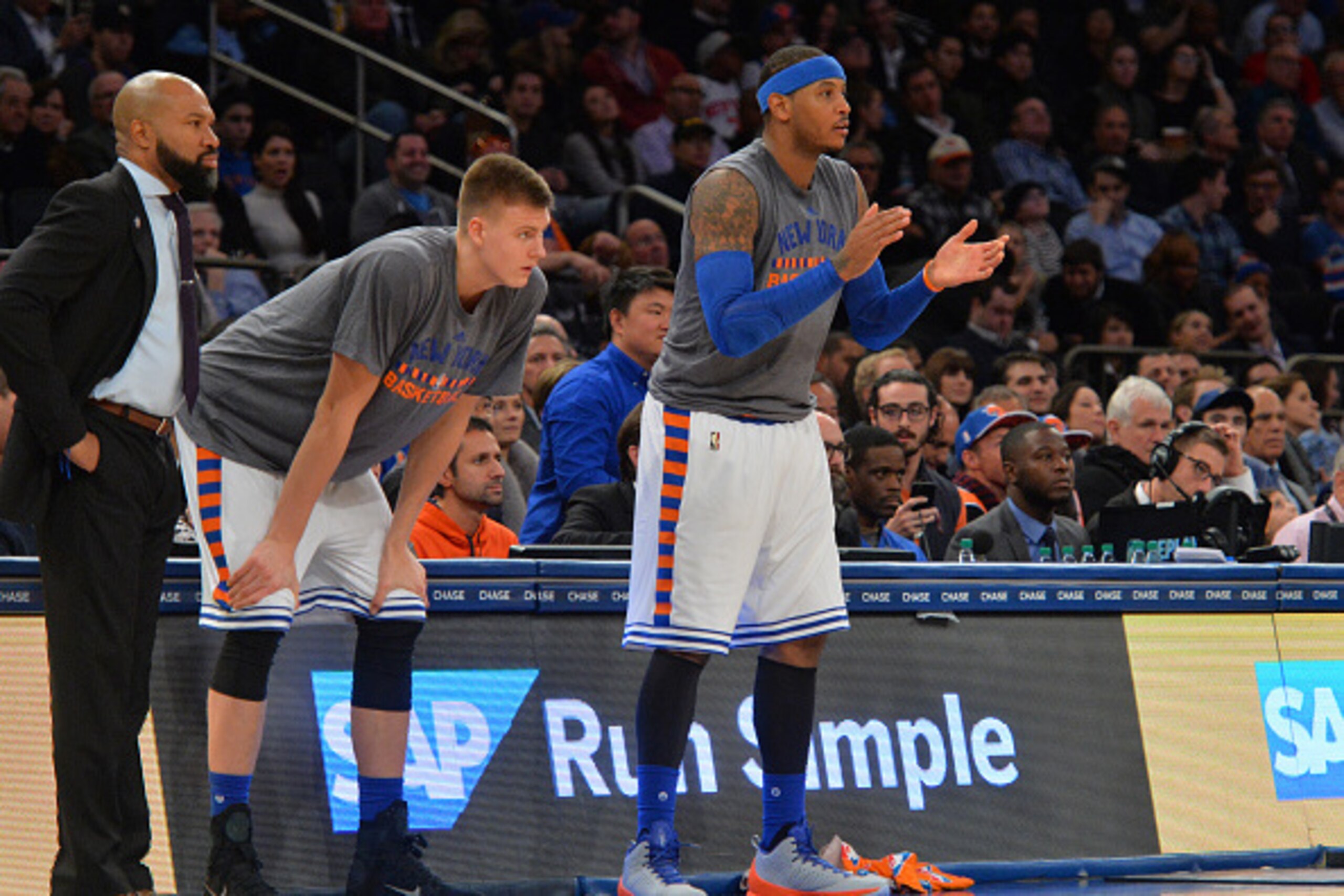 NEW YORK,NY - NOVEMBER 17: Kristaps Porzingis #6 , Carmelo Anthony #7 and Head Coach Derek Fisher of the New York Knicks against the Charlotte Hornets at Madison Square Garden on November 17, 2015 in New York,New York NOTE TO USER: User expressly acknowle NEW YORK,NY - NOVEMBER 17: Kristaps Porzingis #6 , Carmelo Anthony #7 and Head Coach Derek Fisher of the New York Knicks against the Charlotte Hornets at Madison Square Garden on November 17, 2015 in New York,New York NOTE TO USER: User expressly acknowle