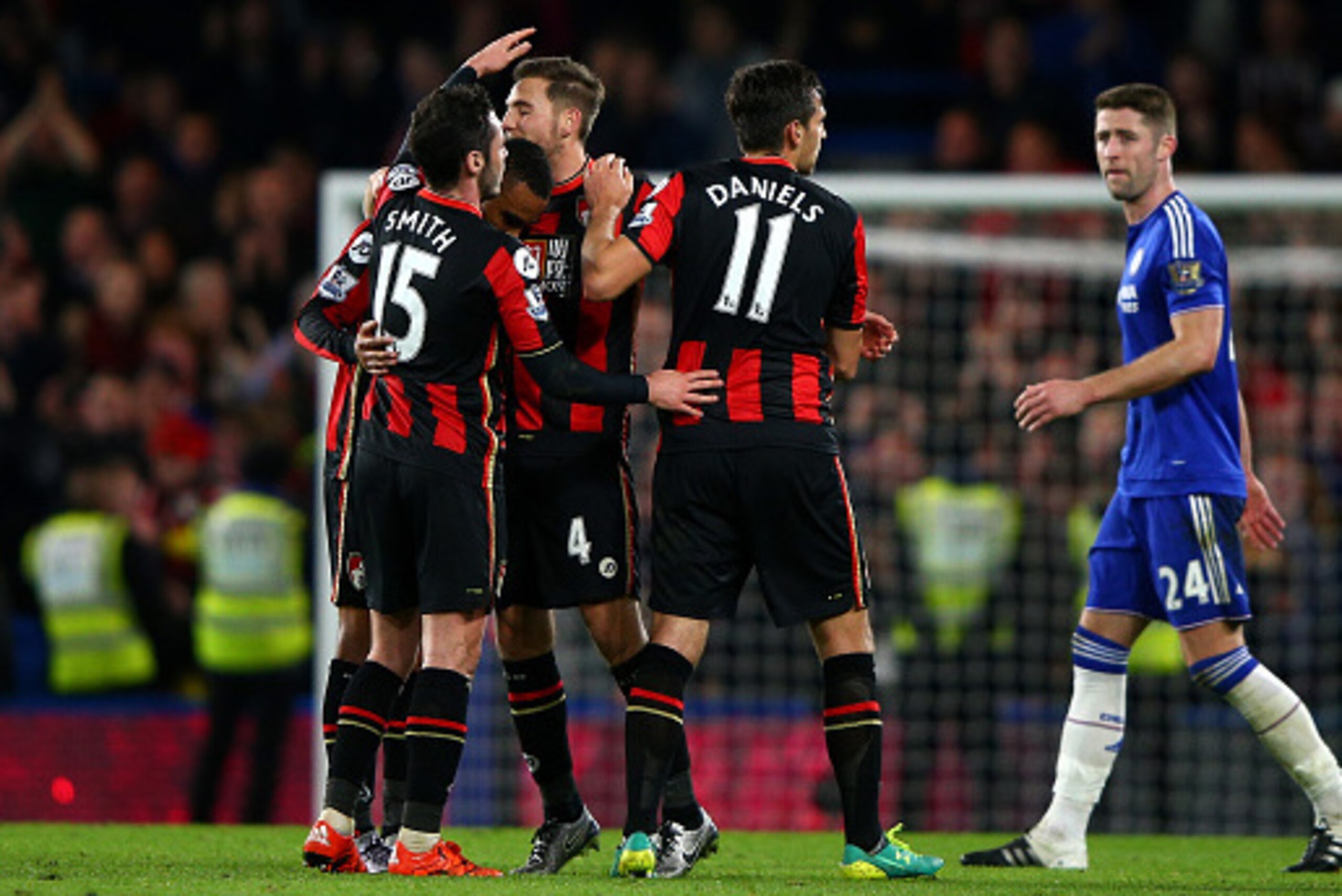 LONDON, ENGLAND - DECEMBER 05:  Bournemouth players Adam Smith (1sr L), Junior Stanislas (2nd L), Dan Gosling (3rd L) and Charlie Daniels (2nd R) celebrate their 1-0 win while Gary Cahill (1st R) of Chelsea leaves the pitch after the Barclays Premier Leag
