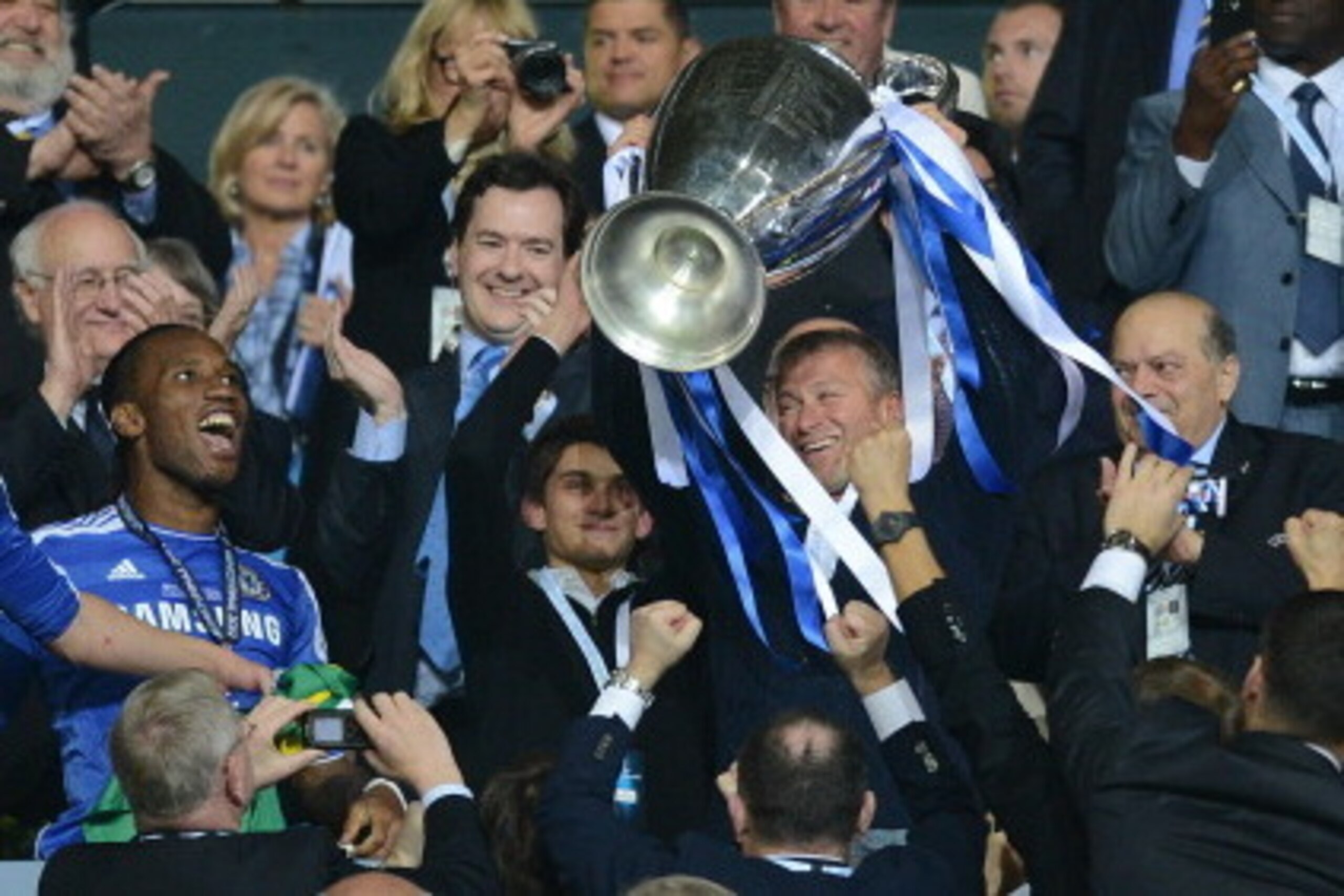 Chelsea's Russian owner Roman Abramovich (3dR) holds the trophy after the UEFA Champions League final football match between FC Bayern Muenchen and Chelsea FC on May 19, 2012 at the Fussball Arena stadium in Munich.  Chelsea won 4-3 in the penalty phase. 