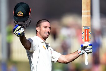 Australian batsman Shaun Marsh celebrates scoring his century against the West Indies on the first day of the first cricket Test match in Hobart on December 10, 2015.   AFP PHOTO / William WEST   --IMAGE RESTRICTED TO EDITORIAL USE - NO COMMERCIAL USE-- /