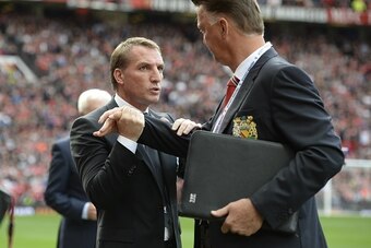Manchester United's Dutch manager Louis van Gaal (R) greets Liverpool's Northern Irish manager  Brendan Rodgers (L) ahead of the English Premier League football match between Manchester United and Liverpool at Old Trafford in Manchester, north west Englan