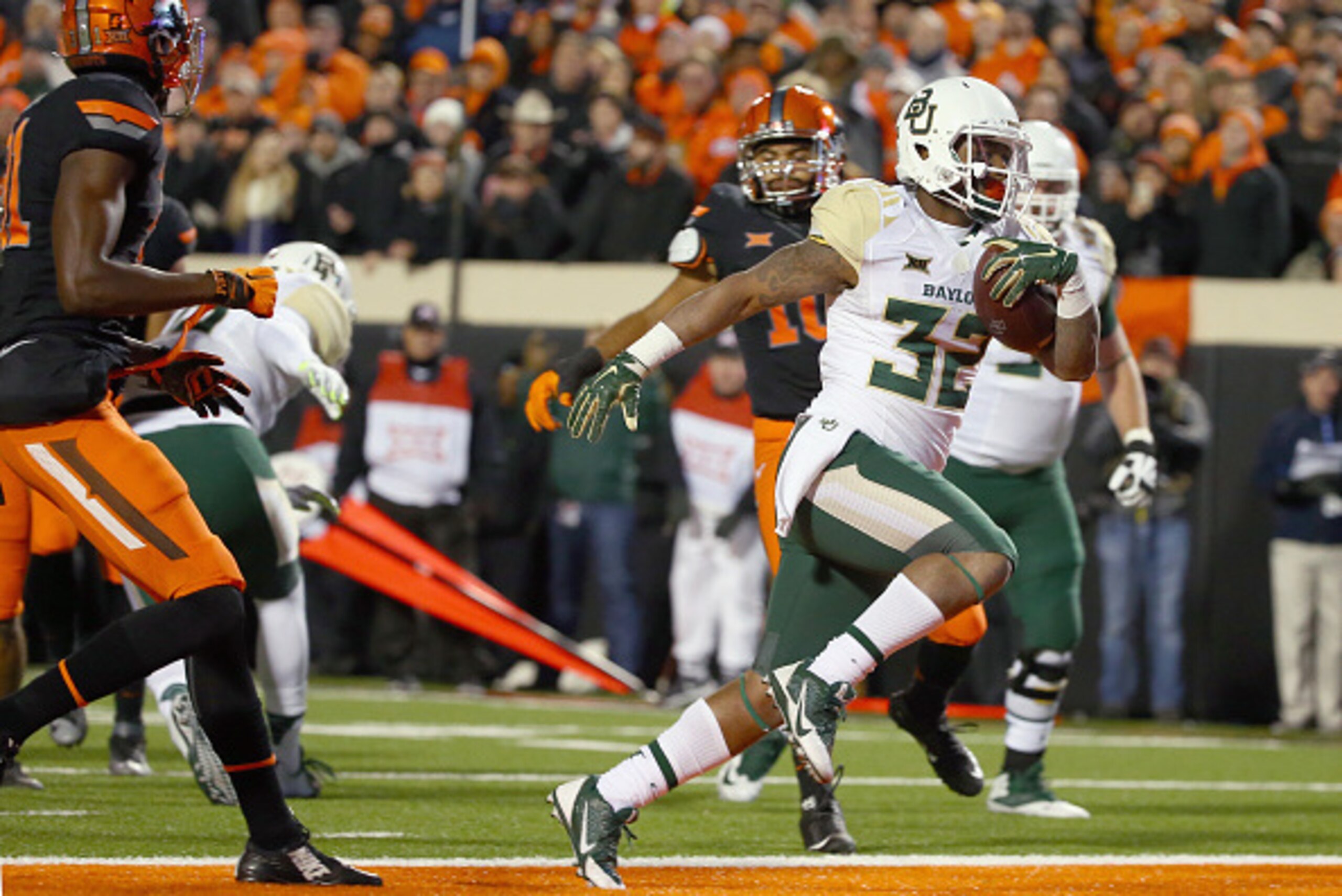 STILLWATER, OK - NOVEMBER 21:  Shock Linwood #32 of the Baylor Bears scores a touchdown against Tre Flowers #31 of the Oklahoma State Cowboys and Seth Jacobs #10 of the Oklahoma State Cowboys in the first quarter at Boone Pickens Stadium on November 21, 2
