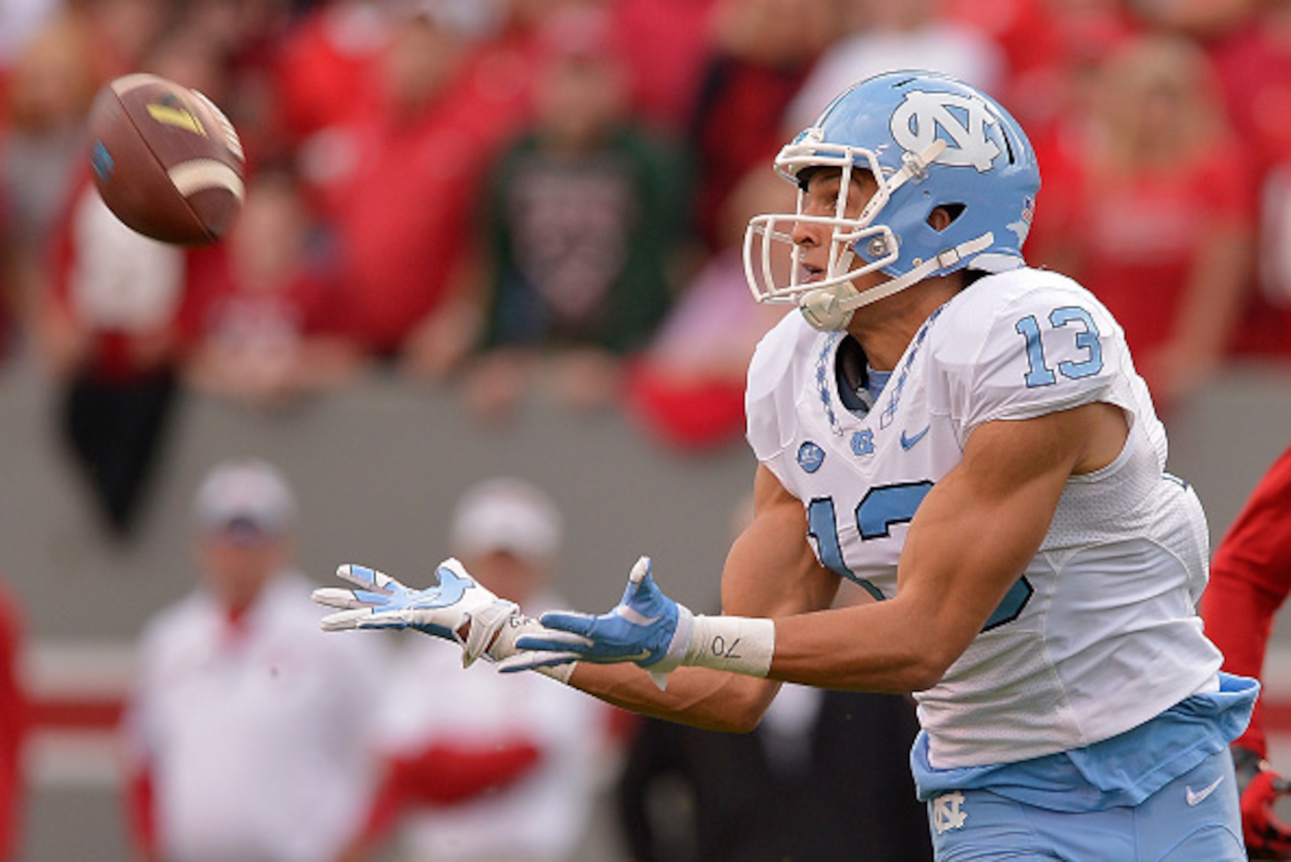 RALEIGH, NC - NOVEMBER 28:  Mack Hollins #13 of the North Carolina Tar Heels makes a catch against the North Carolina State Wolfpack during their game at Carter-Finley Stadium on November 28, 2015 in Raleigh, North Carolina. North Carolina won 45-34.  (Ph