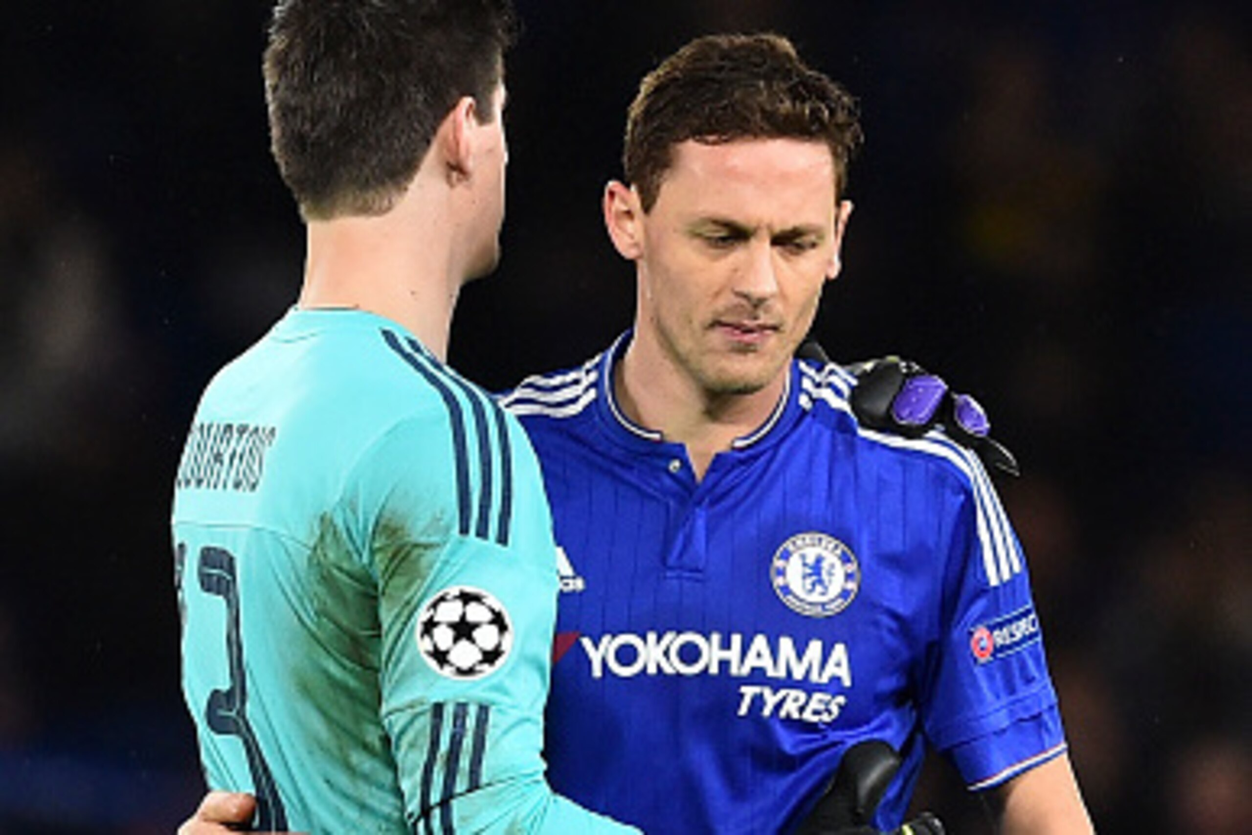Chelsea's Serbian midfielder Nemanja Matic (R) emrbaces Chelsea's Belgian goalkeeper Thibaut Courtois (L) at the end of the UEFA Champions League Group G football match between Chelsea and Porto at Stamford Bridge in London on December 9, 2015.  AFP PHOTO