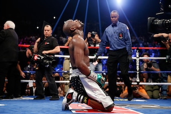 LAS VEGAS, NV - SEPTEMBER 12:  Floyd Mayweather Jr. kneels on the mat after winning his WBC/WBA welterweight title fight against Andre Berto at MGM Grand Garden Arena on September 12, 2015 in Las Vegas, Nevada. Mayweather won the fight by unanimous decisi