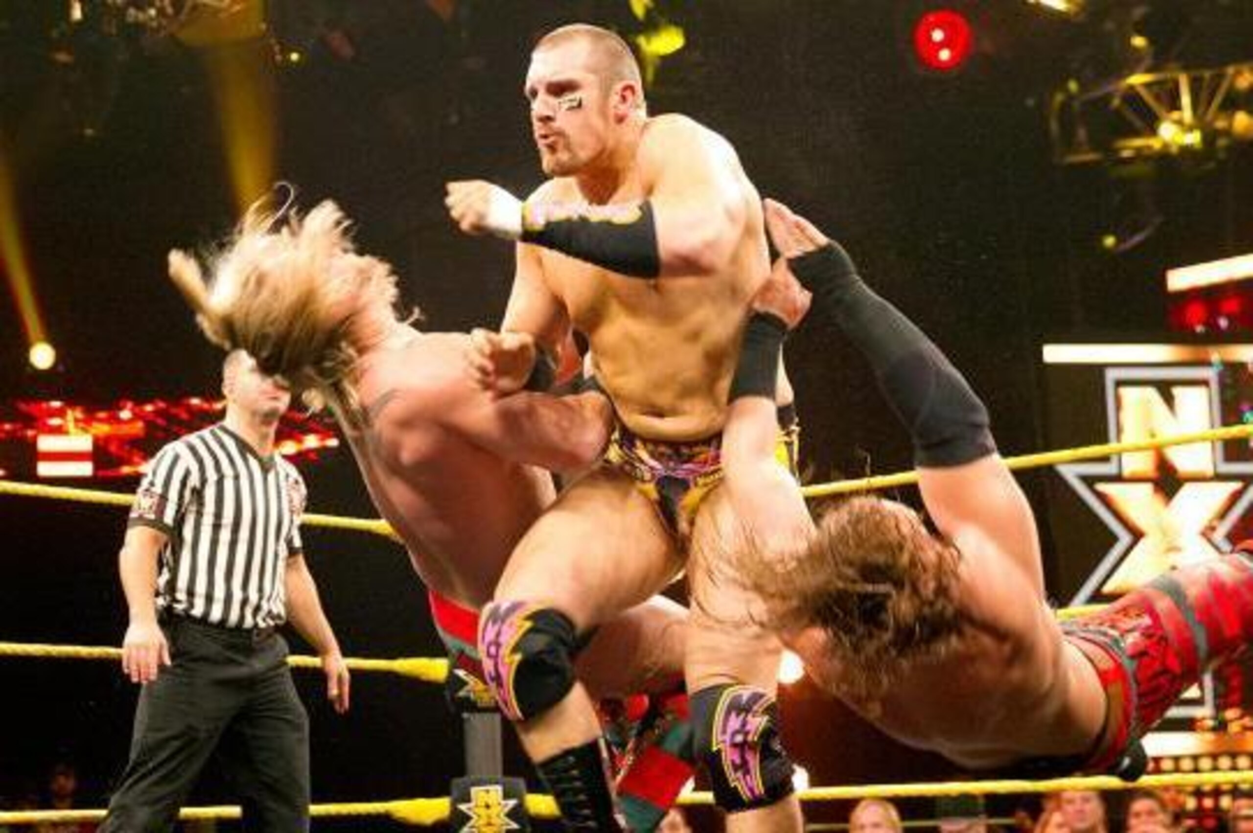 Mojo Rawley bowls over Blake and Murphy.