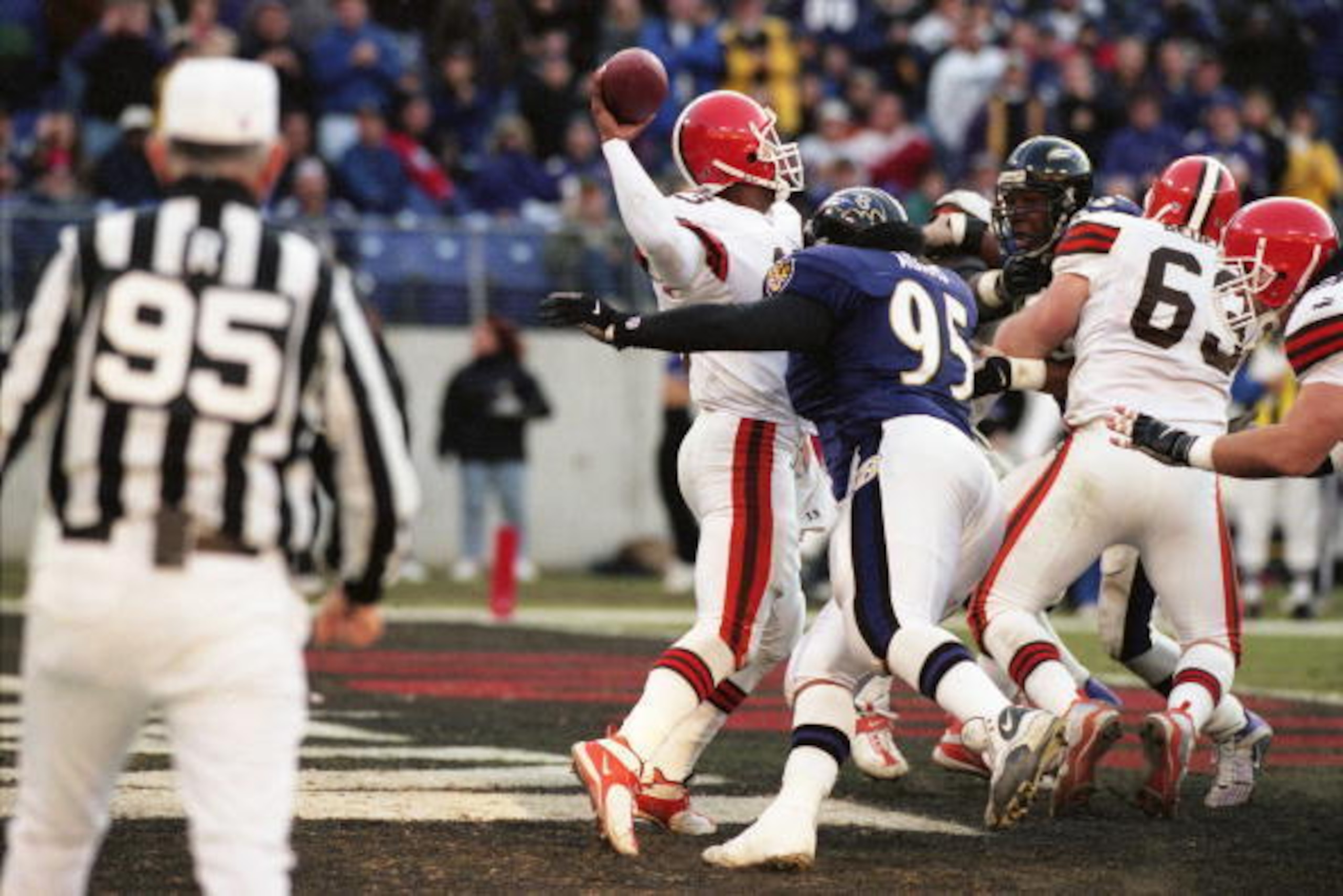 BALTIMORE, MD - NOVEMBER 26: Quarter back Spergon Wynn #13 of the Cleveland Browns passed just as he was sacked by Defensive Tackle Sam Adams #95 of the Baltimore Ravens at PSINet Ravens Stadium on November 26, 2000 in Baltimore, Maryland. The Ravens won BALTIMORE, MD - NOVEMBER 26: Quarter back Spergon Wynn #13 of the Cleveland Browns passed just as he was sacked by Defensive Tackle Sam Adams #95 of the Baltimore Ravens at PSINet Ravens Stadium on November 26, 2000 in Baltimore, Maryland. The Ravens won