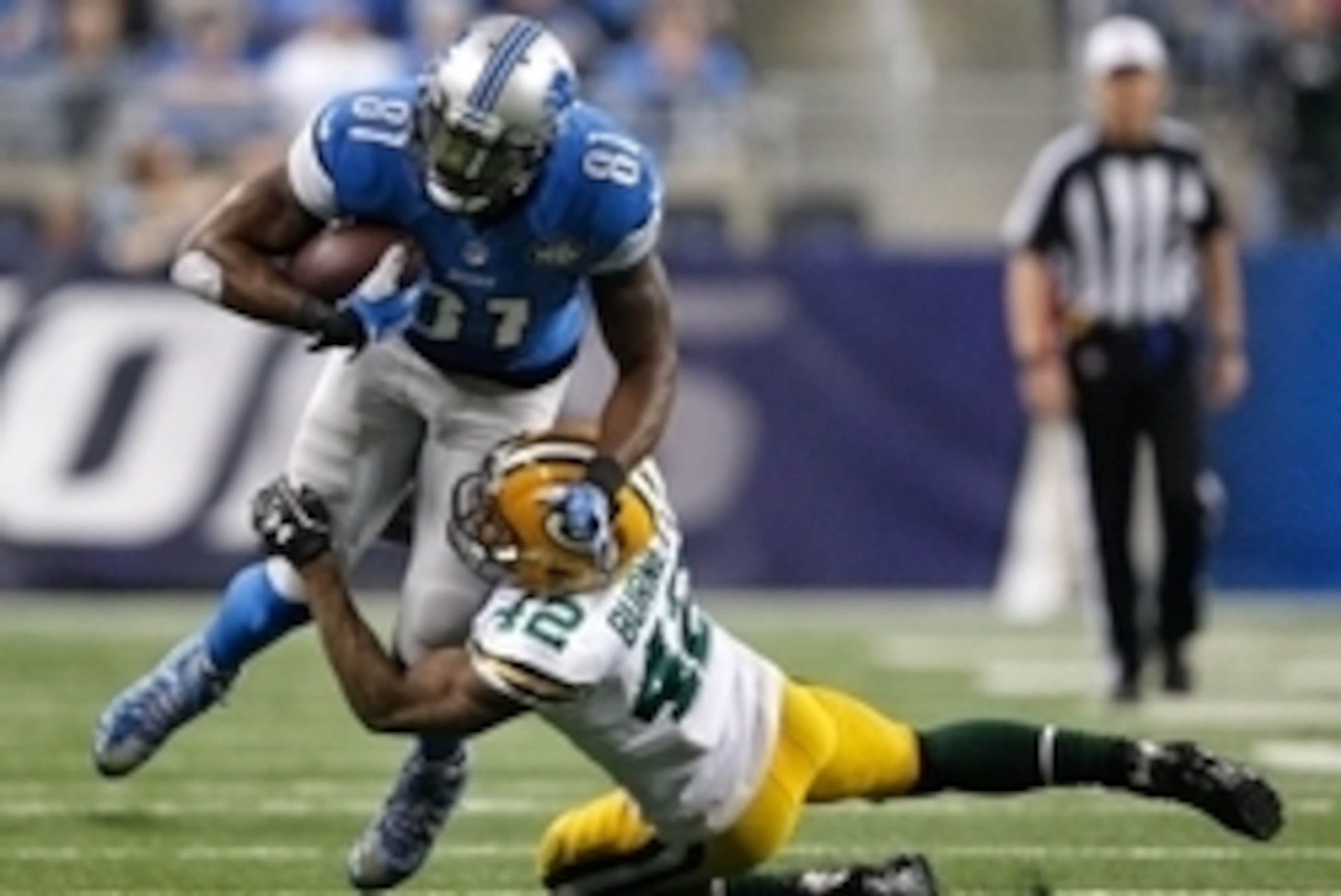 Dec 3, 2015; Detroit, MI, USA; Detroit Lions wide receiver Calvin Johnson (81) gets tackled by Green Bay Packers strong safety Morgan Burnett (42) during the first quarter at Ford Field. Packers win 27-23. Mandatory Credit: Raj Mehta-USA TODAY Sports