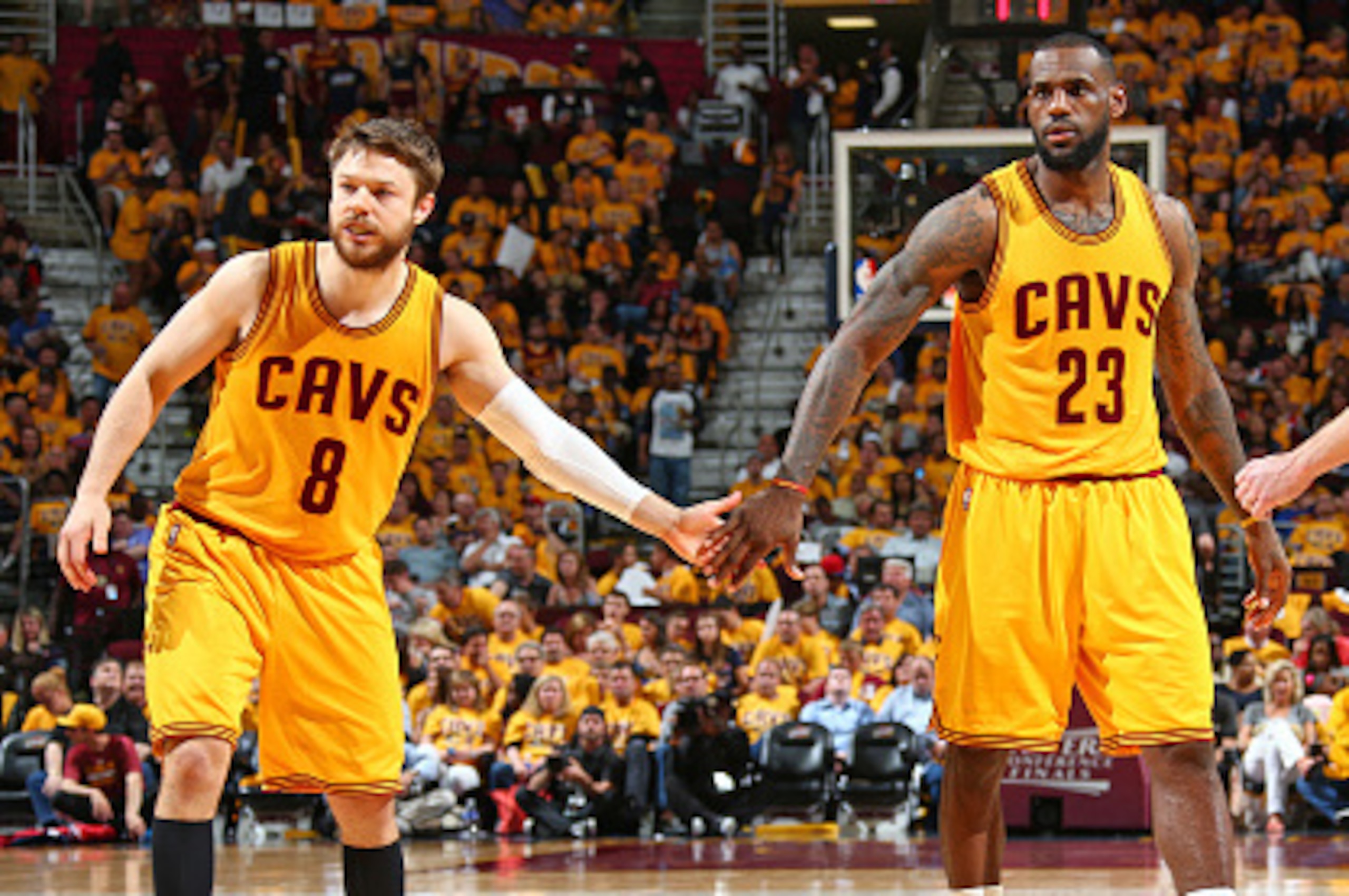 CLEVELAND, OH - MAY 24:  LeBron James #23 shakes hands with Matthew Dellavedova #8 of the Cleveland Cavaliers in Game Three of the Eastern Conference Finals against the Atlanta Hawks during the 2015 NBA Playoffs on May 24, 2015 at Quicken Loans Arena in C