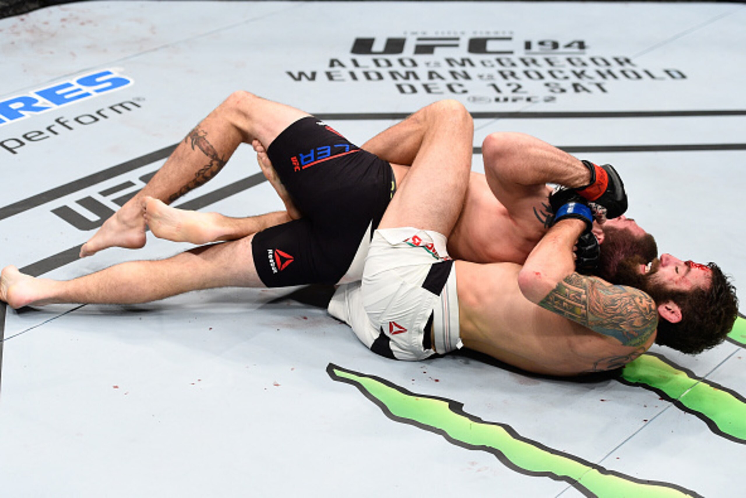 LAS VEGAS, NEVADA - DECEMBER 10:  (Bottom) Michael Chiesa submits Jim Miller in their lightweight bout during the UFC Fight Night event at The Chelsea at the Cosmopolitan of Las Vegas on December 10, 2015 in Las Vegas, Nevada.  (Photo by Jeff Bottari/Zuff