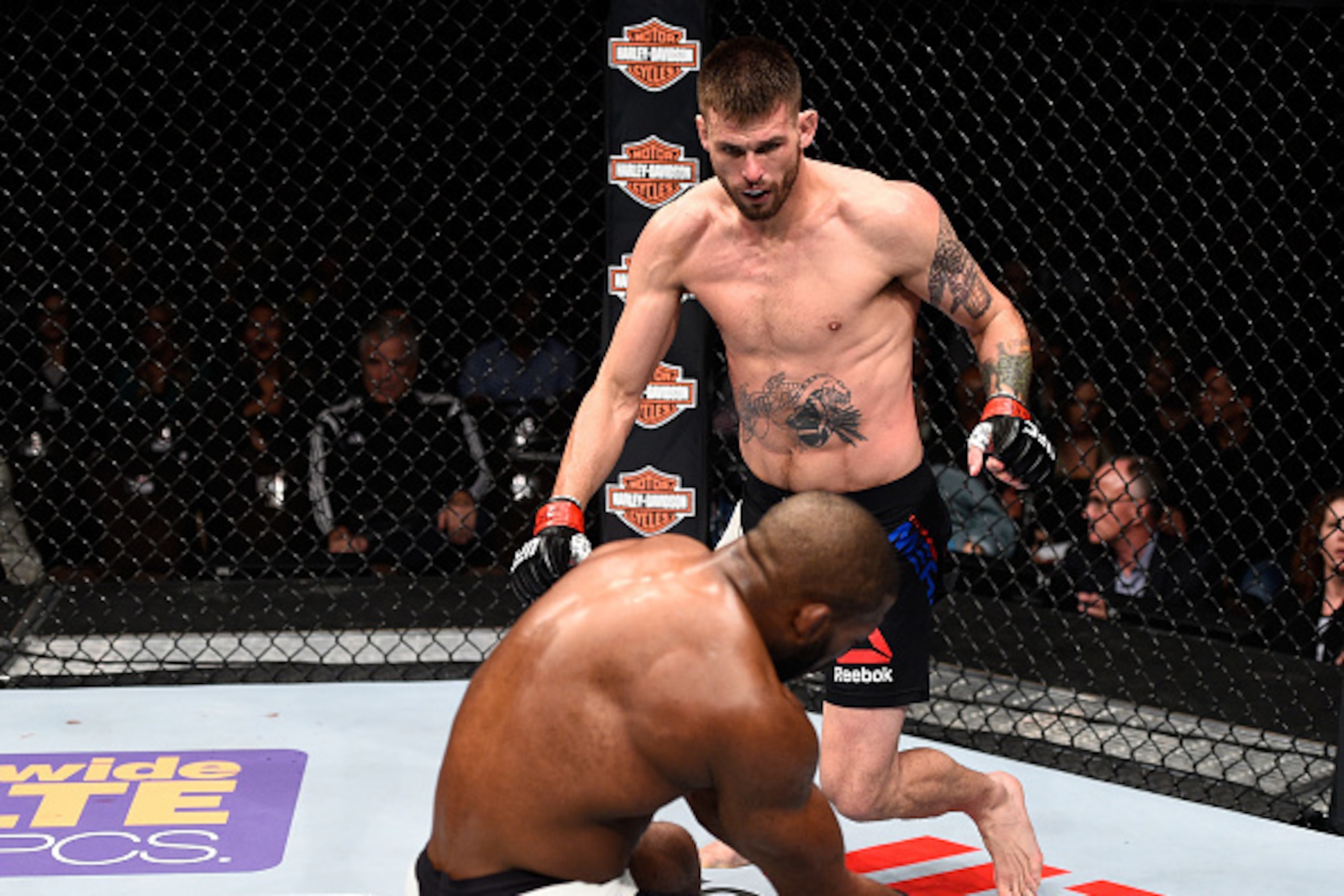 LAS VEGAS, NEVADA - DECEMBER 10:  (Top) Tim Means knocks out John Howard in their welterweight bout during the UFC Fight Night event at The Chelsea at the Cosmopolitan of Las Vegas on December 10, 2015 in Las Vegas, Nevada.  (Photo by Jeff Bottari/Zuffa L