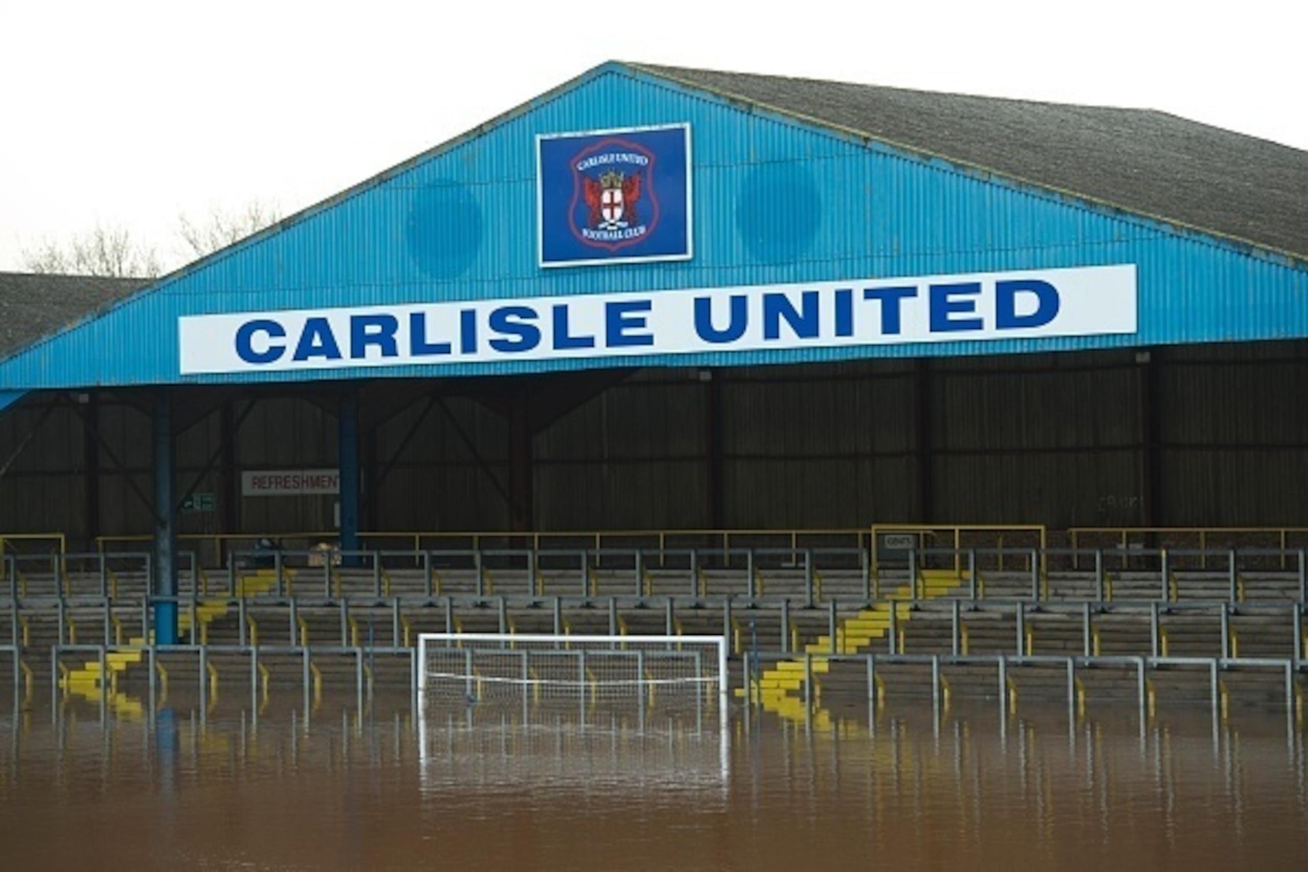 Flood water covers the pitch and some of the stands at Carlisle United Football Club's Brunton Park stadium in Carlisle, north west England on December 7, 2015, after heavy flooding caused by Storm Desmond. British Prime Minister David Cameron visited are