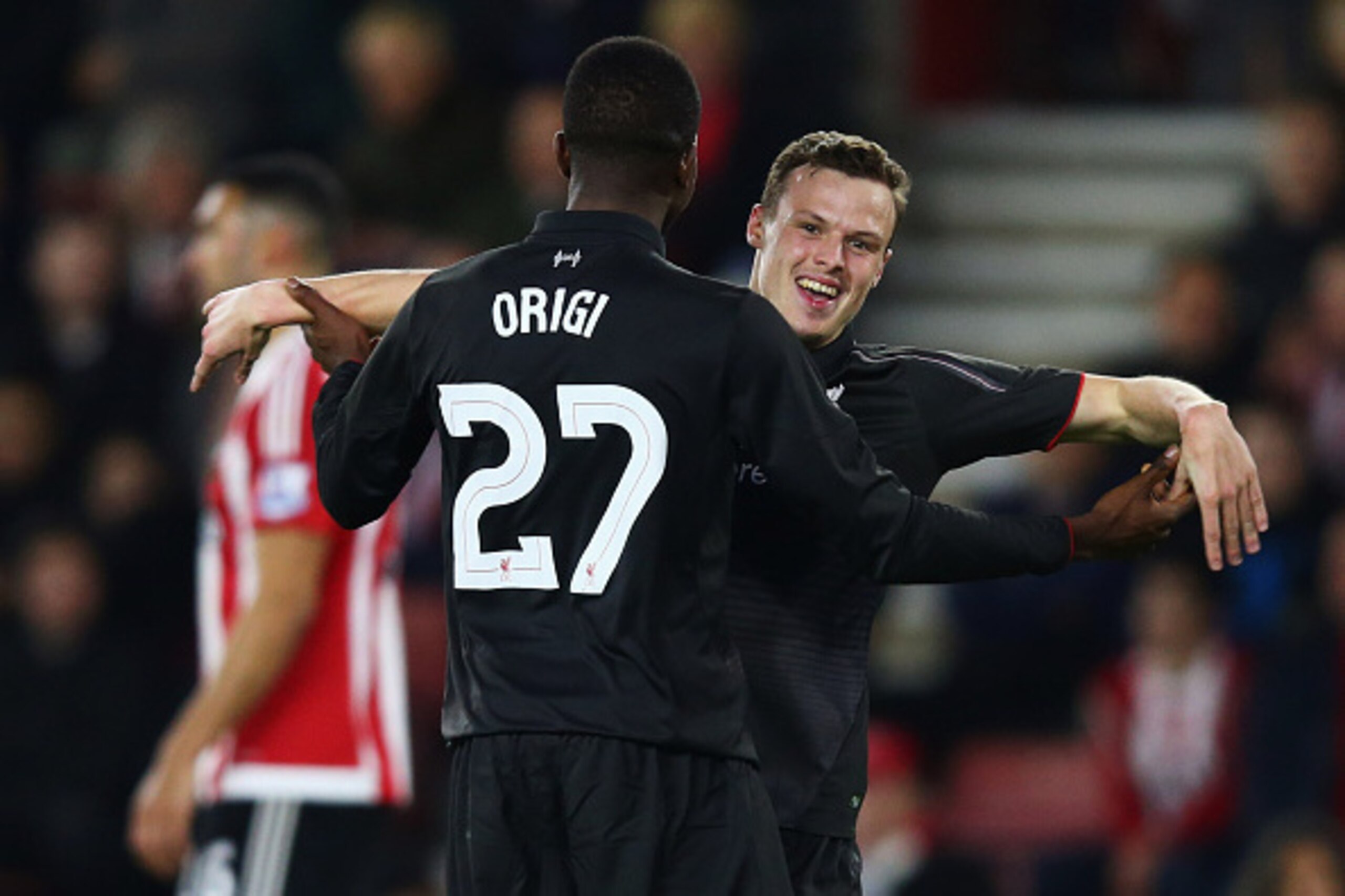 SOUTHAMPTON, ENGLAND - DECEMBER 02: Divock Origi of Liverpool (27) celebrates with Brad Smith as he scores their sixth goal and completes his hat trick during the Capital One Cup quarter final match between Southampton and Liverpool at St Mary's Stadium SOUTHAMPTON, ENGLAND - DECEMBER 02: Divock Origi of Liverpool (27) celebrates with Brad Smith as he scores their sixth goal and completes his hat trick during the Capital One Cup quarter final match between Southampton and Liverpool at St Mary's Stadium