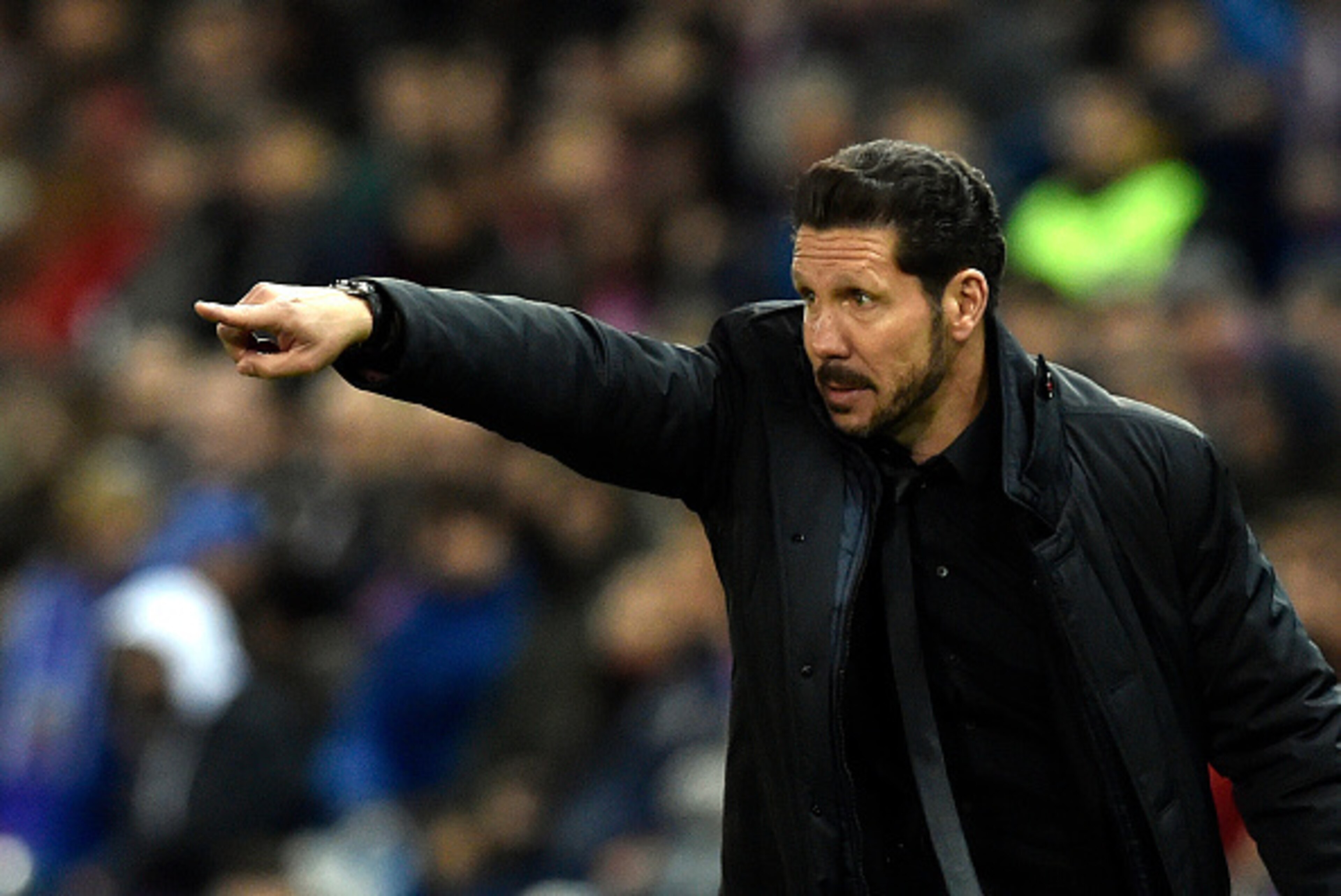 Atletico Madrid's Argentinian coach Diego Simeone gestures during the Spanish league football match Club Atletico de Madrid vs RCD Espanyol at the Vicente Calderon stadium in Madrid on November 28, 2015.    / AFP / GERARD JULIEN        (Photo credit shoul