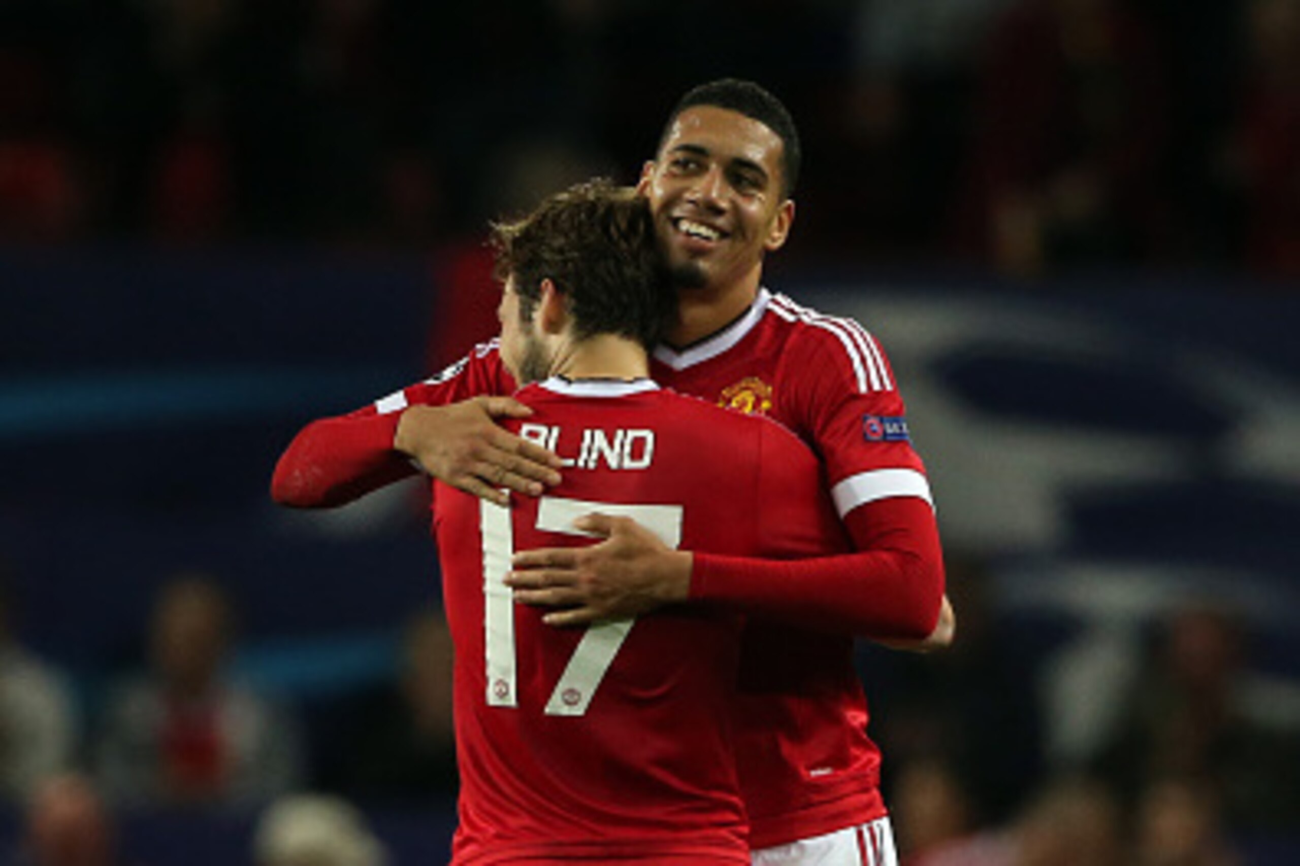 MANCHESTER, ENGLAND - SEPTEMBER 30:  Chris Smalling of Manchester United who scored the winning goal gets congratulated by Daley Blind of Manchester United at the end of the UEFA Champions League match between Manchester United and Wolfsburg at Old Traffo