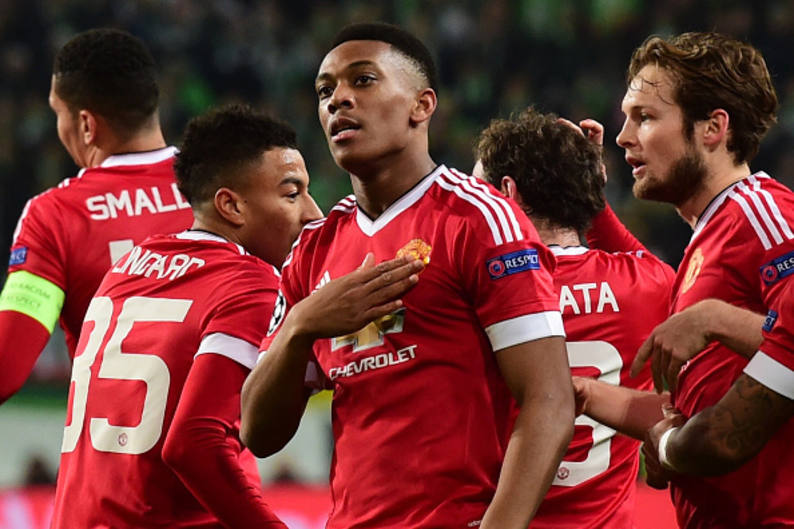 Manchester United's French striker Anthony Martial (c) reacts after scoring the opening goal during the UEFA Champions League Group B second-leg football match VfL Wolfsburg vs Manchester United in Wolfsburg, central Germany, on December 8, 2015. AFP PHOT
