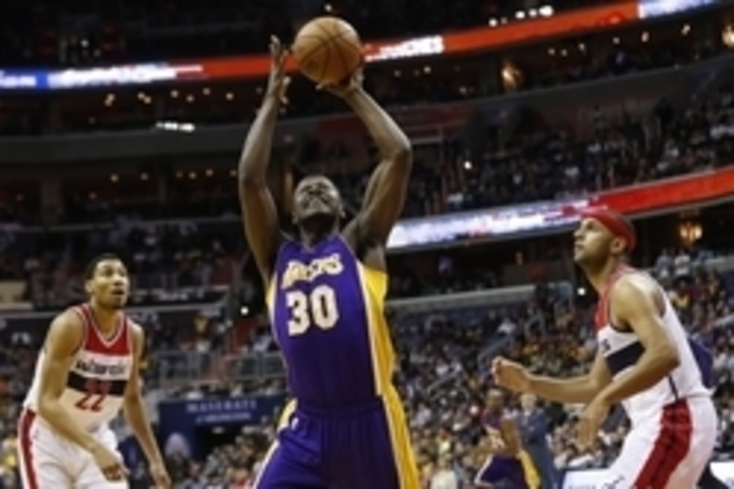 Dec 2, 2015; Washington, DC, USA; Los Angeles Lakers forward Julius Randle (30) leaps to rebound the ball as Washington Wizards guard Jared Dudley (1) looks on in the second quarter at Verizon Center. The Lakers won 108-104. Mandatory Credit: Geoff Burke-