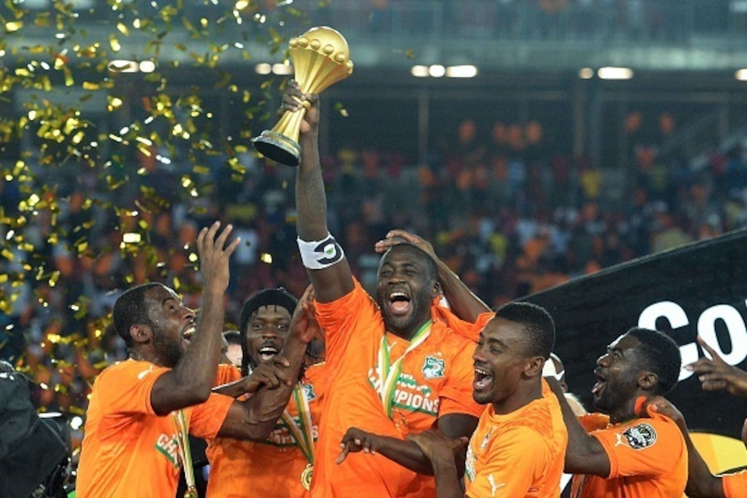 Ivory Coast's midfielder Yaya Toure (C) raises the trophy at the end of the 2015 African Cup of Nations final football match between Ivory Coast and Ghana in Bata on February 8, 2015. Ivory Coast won 9 to 8 on penalties.  AFP PHOTO / KHALED DESOUKI       