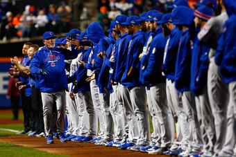 NEW YORK, NY - OCTOBER 17:  Joe Maddon #70 of the Chicago Cubs high fives his team during player introductions prior to game one of the 2015 MLB National League Championship Series against the New York Mets at Citi Field on October 17, 2015 in the Flushin