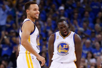 OAKLAND, CA - OCTOBER 27:  Stephen Curry #30 and Draymond Green #23 of the Golden State Warriors react after a three point basket by Green against the New Orleans Pelicans during the NBA season opener at ORACLE Arena on October 27, 2015 in Oakland, Califo