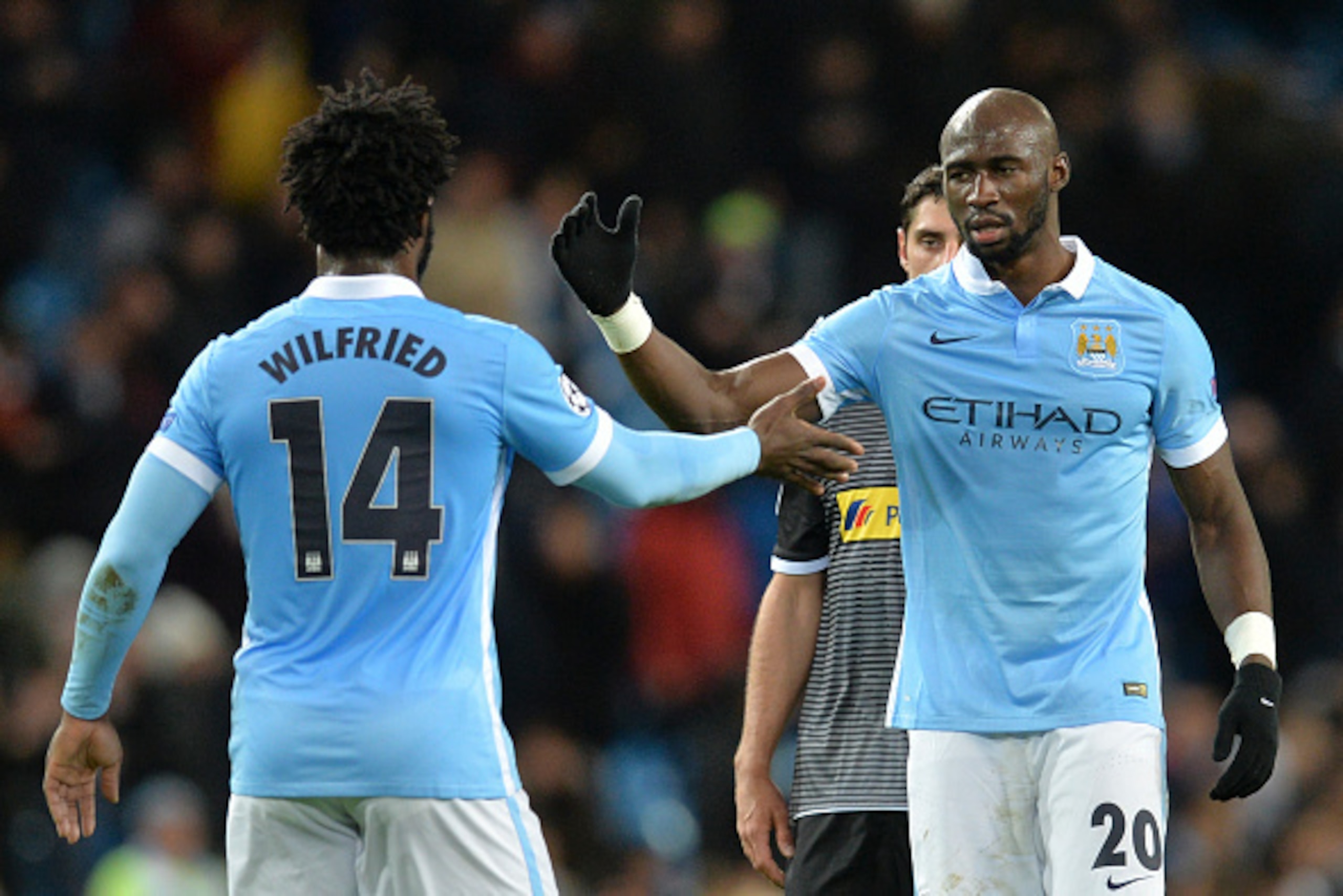 Manchester City's Ivorian striker Wilfried Bony (L) shakes hands with Manchester City's French defender Eliaquim Mangala (R) at the end of the UEFA Champions League Group D football match between Manchester City and Borussia Moenchengladbach at the Etihad