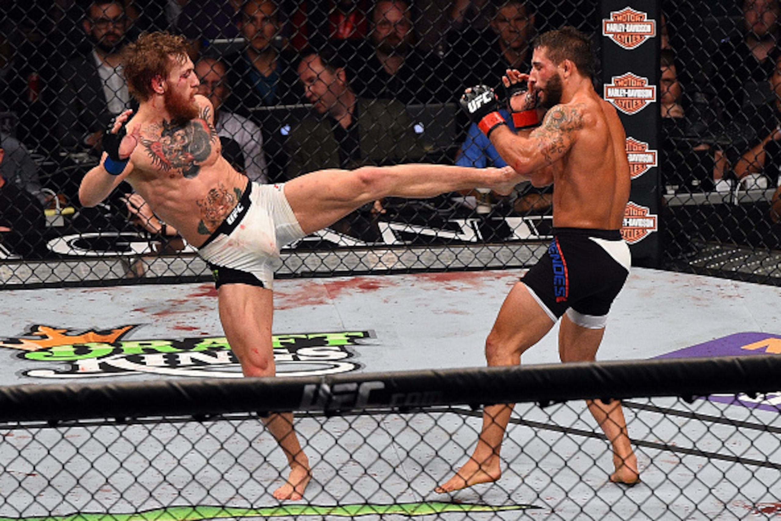 LAS VEGAS, NV - JULY 11:  (L-R) Conor McGregor kicks Chad Mendes during the UFC 189 event inside MGM Grand Garden Arena on July 11, 2015 in Las Vegas, Nevada.  (Photo by Jeff Bottari/Zuffa LLC/Zuffa LLC via Getty Images)