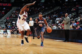 ATLANTA, GA - DECEMBER 22: Corey Maggette #50 of the Charlotte Bobcats dribbles against Marvin Williams #24 of the Atlanta Hawks during a preseason game on December 22, 2011 at Philips Arena in Atlanta, Georgia.  NOTE TO USER: User expressly acknowledges 