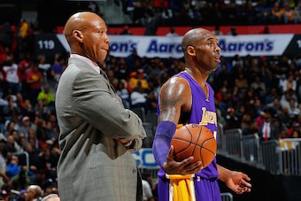 ATLANTA, GA - DECEMBER 04:  Byron Scott of the Los Angeles Lakers looks on as Kobe Bryant #24 prepares to inbounds the ball against the Atlanta Hawks at Philips Arena on December 4, 2015 in Atlanta, Georgia.  NOTE TO USER User expressly acknowledges and a