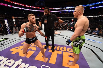 BOSTON, MA - JANUARY 18:  (L-R) Conor McGregor of Ireland and Dennis Siver of Germany meet in the center of the Octagon before their featherweight fight during the UFC Fight Night event at the TD Garden on January 18, 2015 in Boston, Massachusetts. (Photo