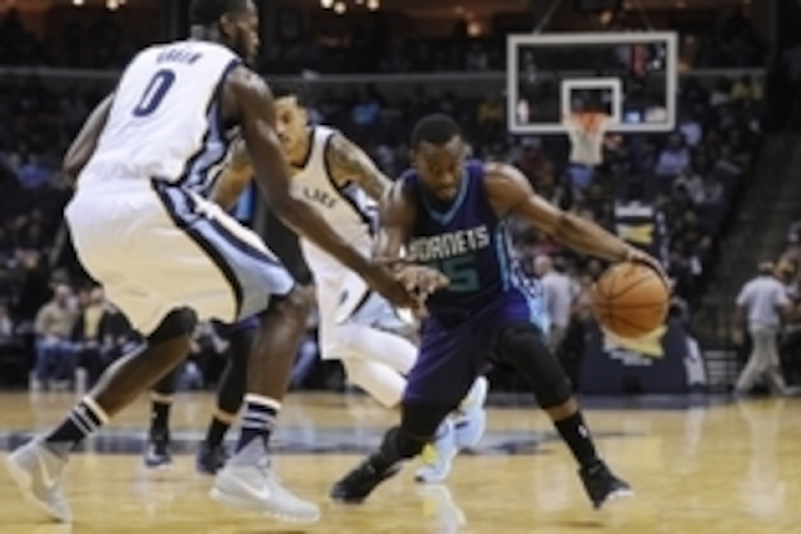 Dec 11, 2015; Memphis, TN, USA; Charlotte Hornets guard Kemba Walker (15) dribbles the ball around Memphis Grizzlies forward JaMychal Green (0) during the second half at FedExForum. The Hornets won 123-99. Mandatory Credit: Justin Ford-USA TODAY Sports