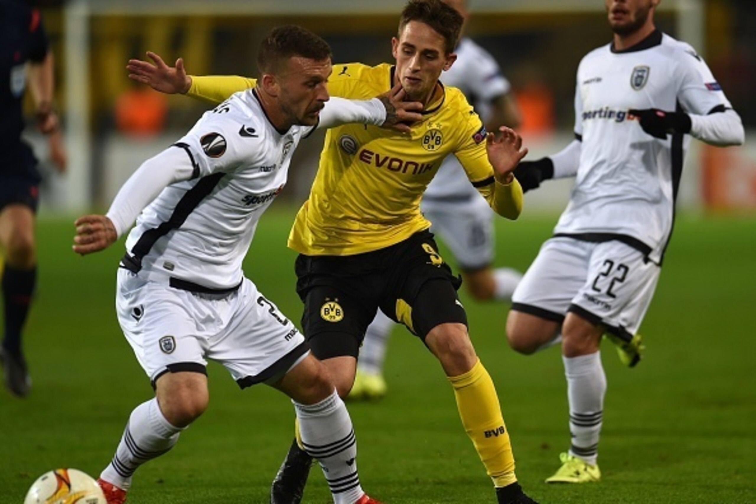 Dortmund's midfielder Adnan Januzaj (C) vies with PAOK´s Giannis Skondras during the UEFA Europa League football match between Borussia Dortmund and PAOK FC at BVB Stadion Dortmund in Dortmund on December 10, 2015.  AFP PHOTO / PATRIK STOLLARZ / AFP / PAT