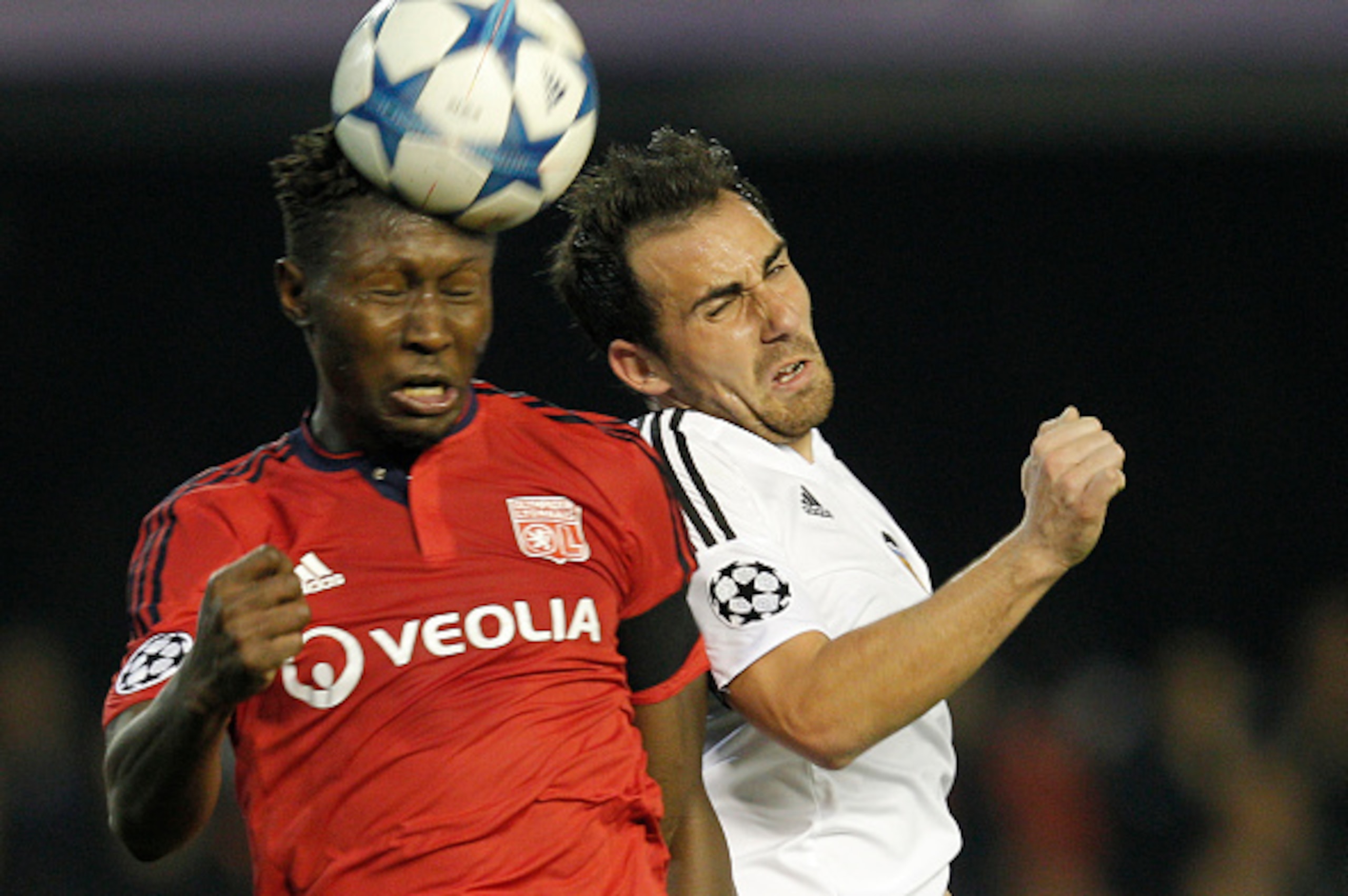 Lyon's defender Mapou Yanga-Mbiwa (L) heads a ball with Valencia's forward Paco Alcacer during the UEFA Champions League football match Valencia CF vs Olympique Lyonnais at the Mestalla stadium in Valencia on December 9, 2015. AFP PHOTO/ JOSE JORDAN / A Lyon's defender Mapou Yanga-Mbiwa (L) heads a ball with Valencia's forward Paco Alcacer during the UEFA Champions League football match Valencia CF vs Olympique Lyonnais at the Mestalla stadium in Valencia on December 9, 2015. AFP PHOTO/ JOSE JORDAN / A