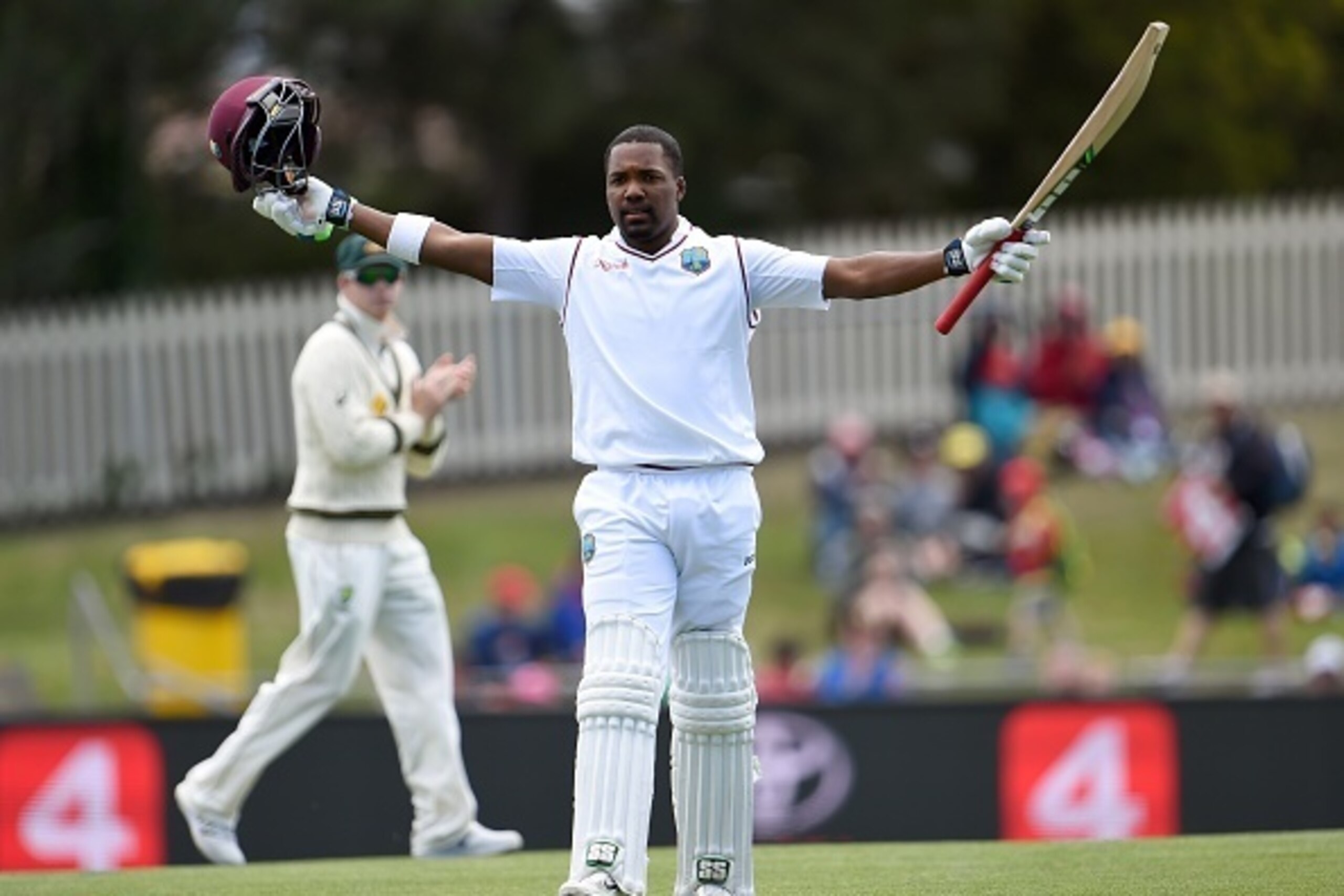 West Indies batsman Darren Bravo celebrates scoring his century against Australia on the third day of the first cricket Test match in Hobart on December 12, 2015.   AFP PHOTO / William WEST   --IMAGE RESTRICTED TO EDITORIAL USE - NO COMMERCIAL USE-- / AFP